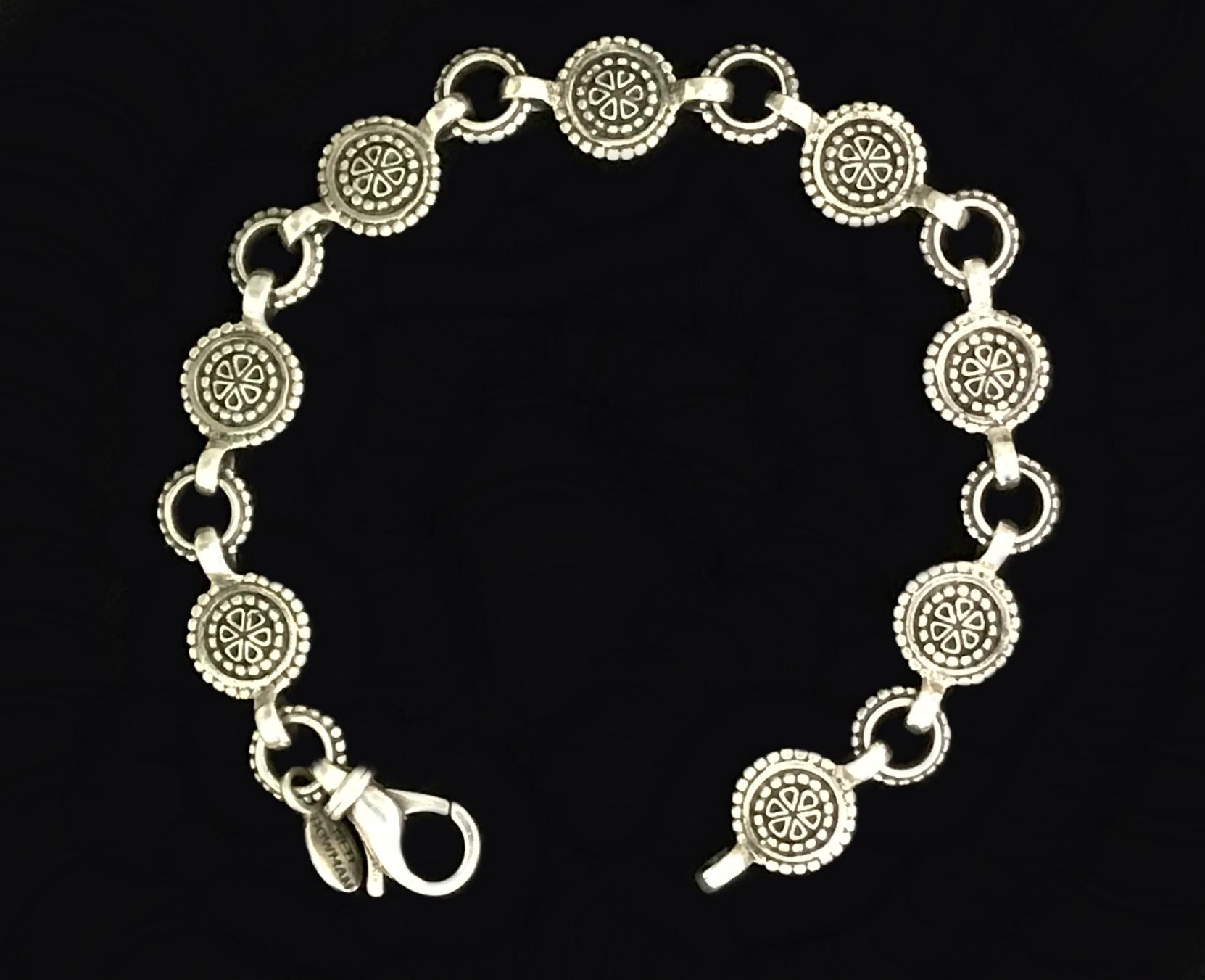 Handmade sterling silver link  bracelet featuring a Fleur de Lis motif fastened with a 