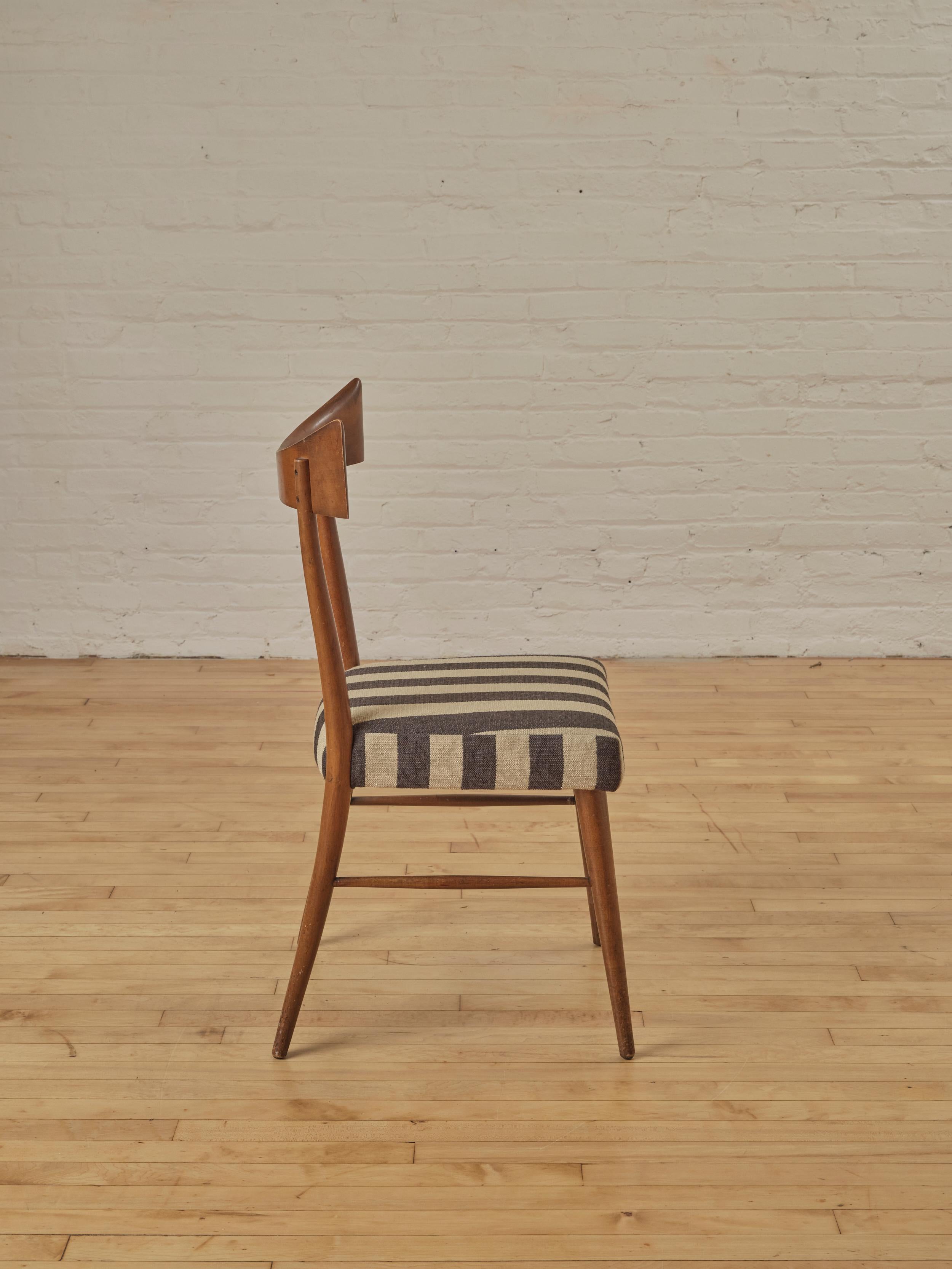 Bowtie Accent Chair by Paul McCobb for Winchendon, featuring a walnut frame and newly reupholstered in striped cotton fabric.

About Paul McCobb: 

Paul McCobb (1917-1969) was a prominent American designer and furniture architect known for his