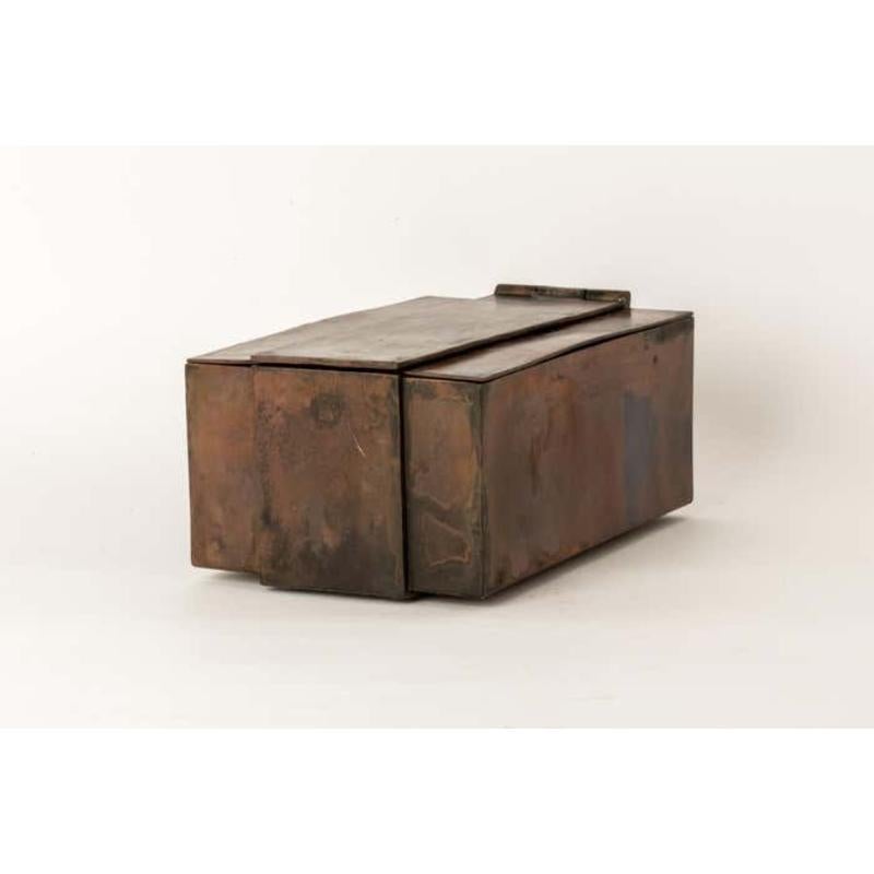 This box is hand-made in brass. It has a unique color that comes from heating the metal, causing it to release impurities and develop a warm, aged look. Its surface showcases a unique charm. Not only is this box a functional storage solution, but