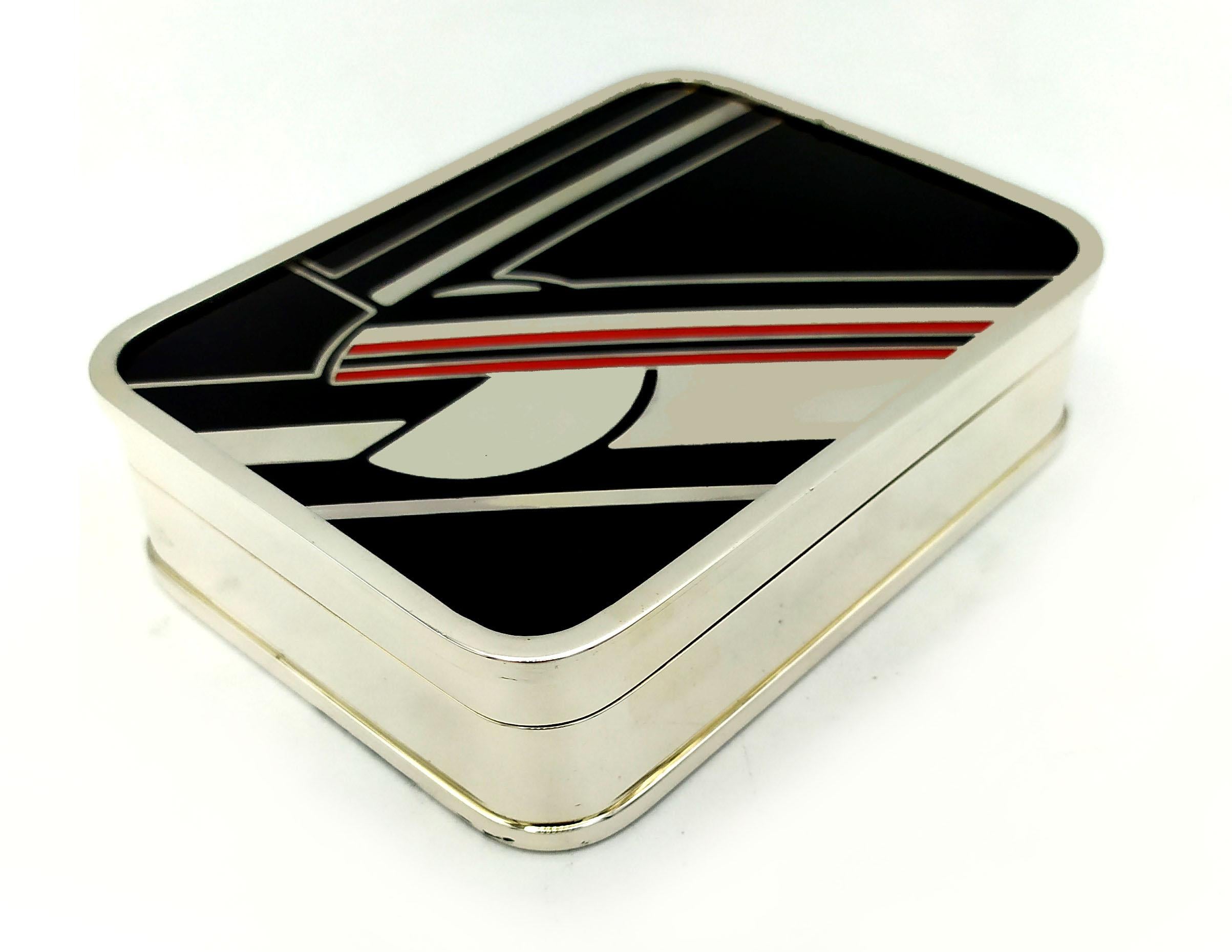 Box Black White and Red enamel is Inspired by drawings by Louis Cartier from the 1920 in Art Deco style and recreated for Cartier USA in the 1976.
It is in 925/1000 Sterling Silver.
Box Black White and Red has hand painted fired enamels geometric