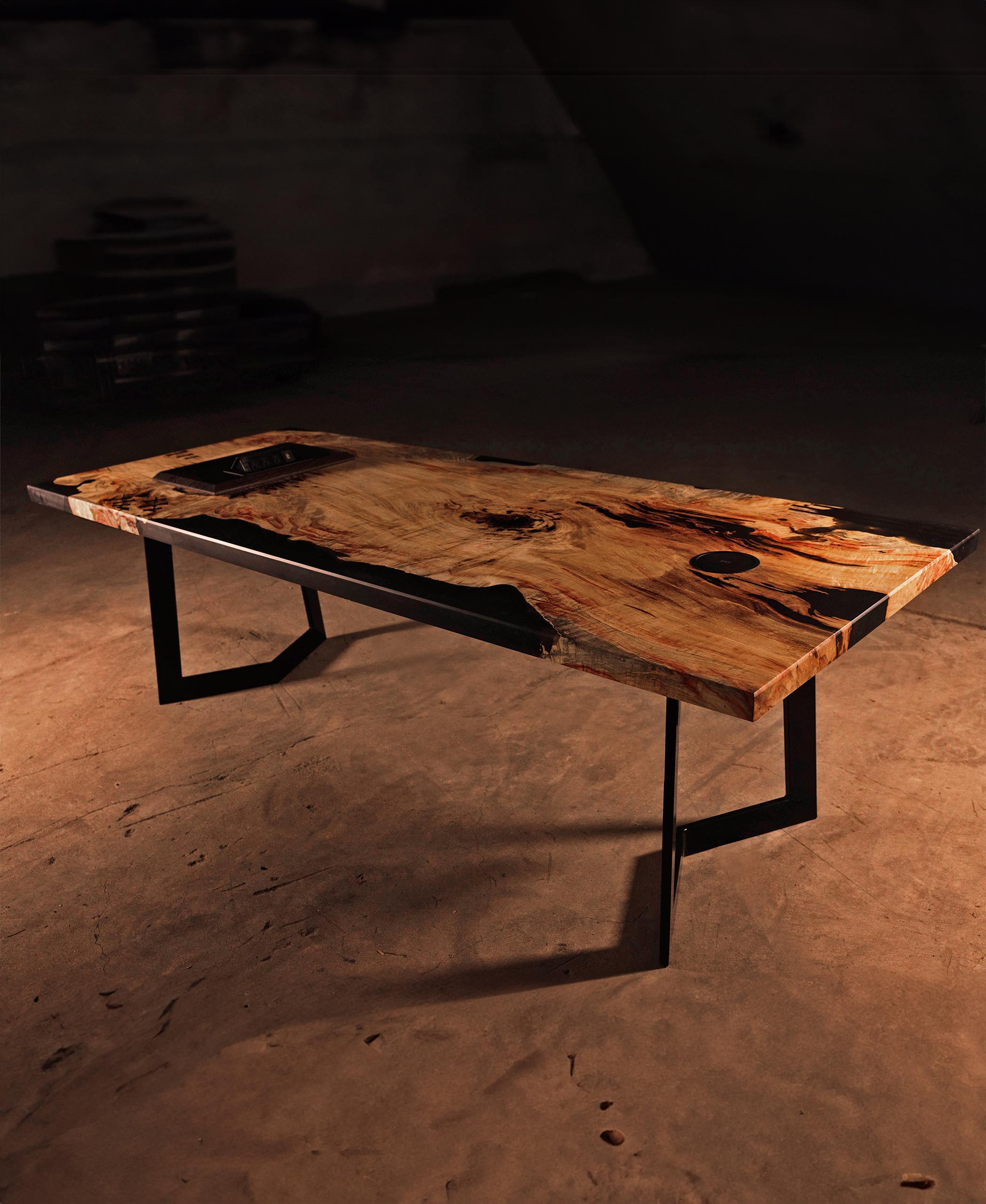 Crafted with Wenge accents, this table boasts intricate bow ties, strips, and inserts, each meticulously placed to accentuate the natural beauty of the wood. A custom base and seamlessly integrated high-end electronics enhance functionality while