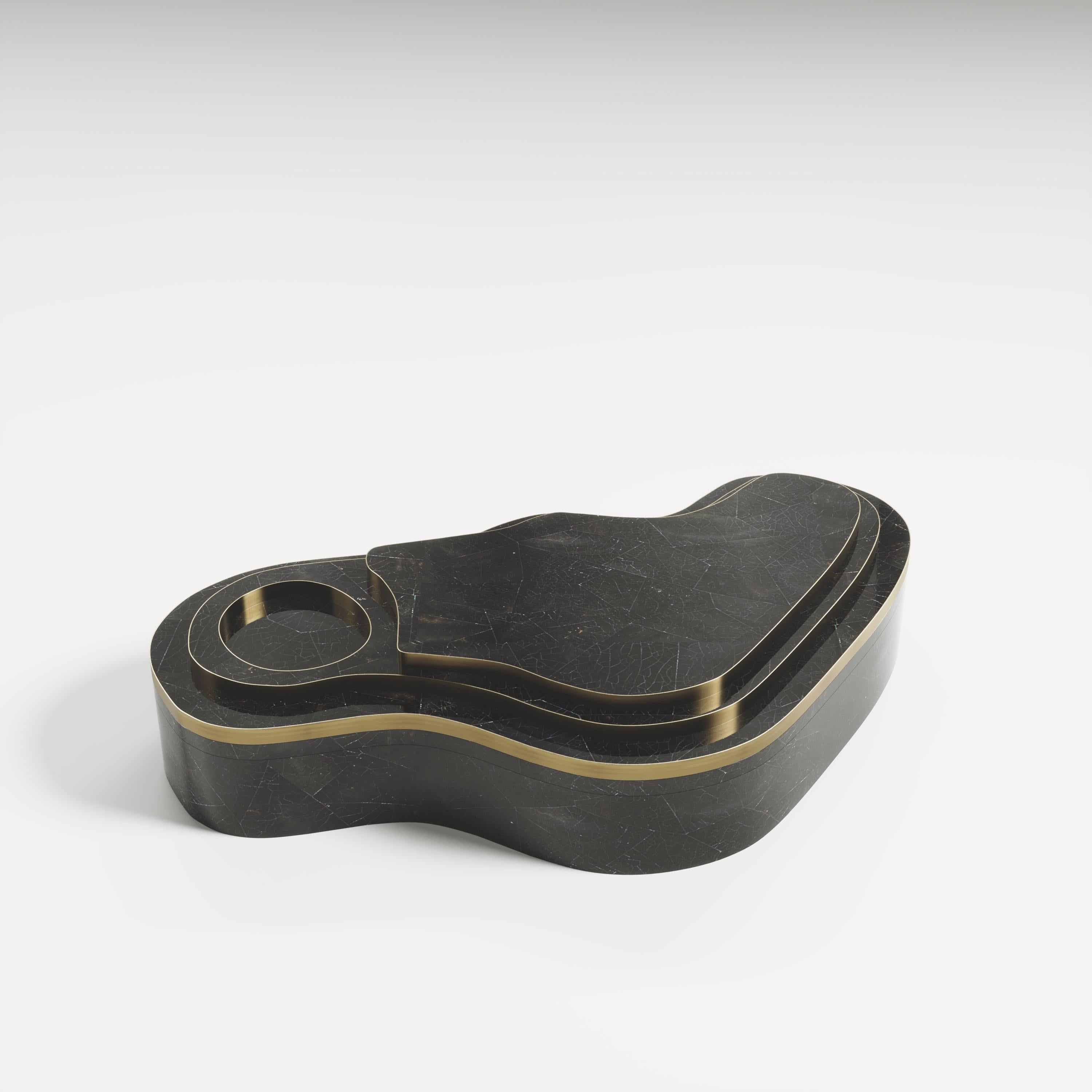 The Mask Box with relief by Kifu Paris is a versatile and organic piece. The amorphous top and base are inlaid in a mixture of black shell and bronze-patina brass. This piece is designed by Kifu Augousti the daughter of Ria and Yiouri Augousti.