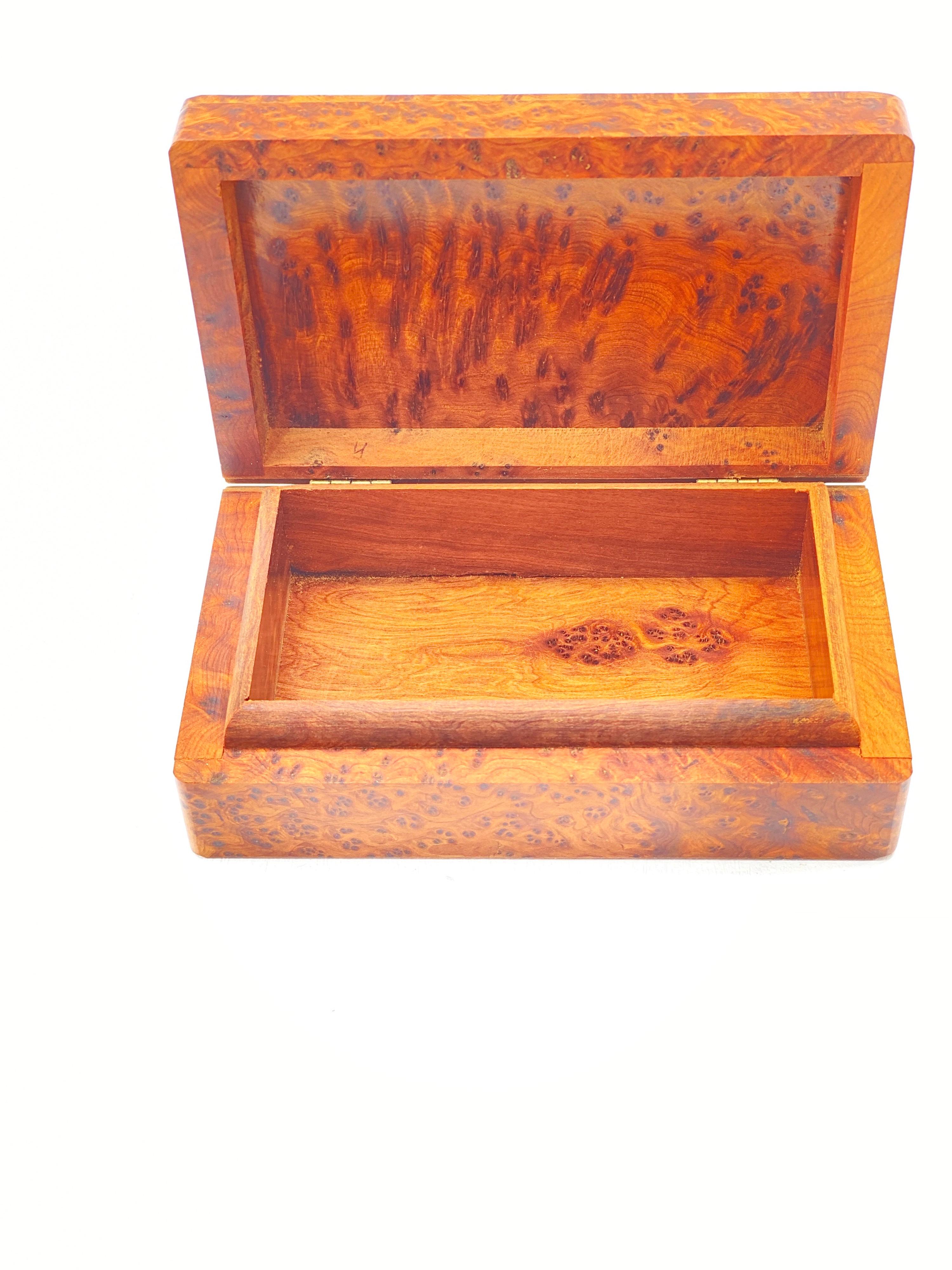 This box is in burl wood. It has been made in France in the 1970's. The color is brown, and it is in an excellent condition.