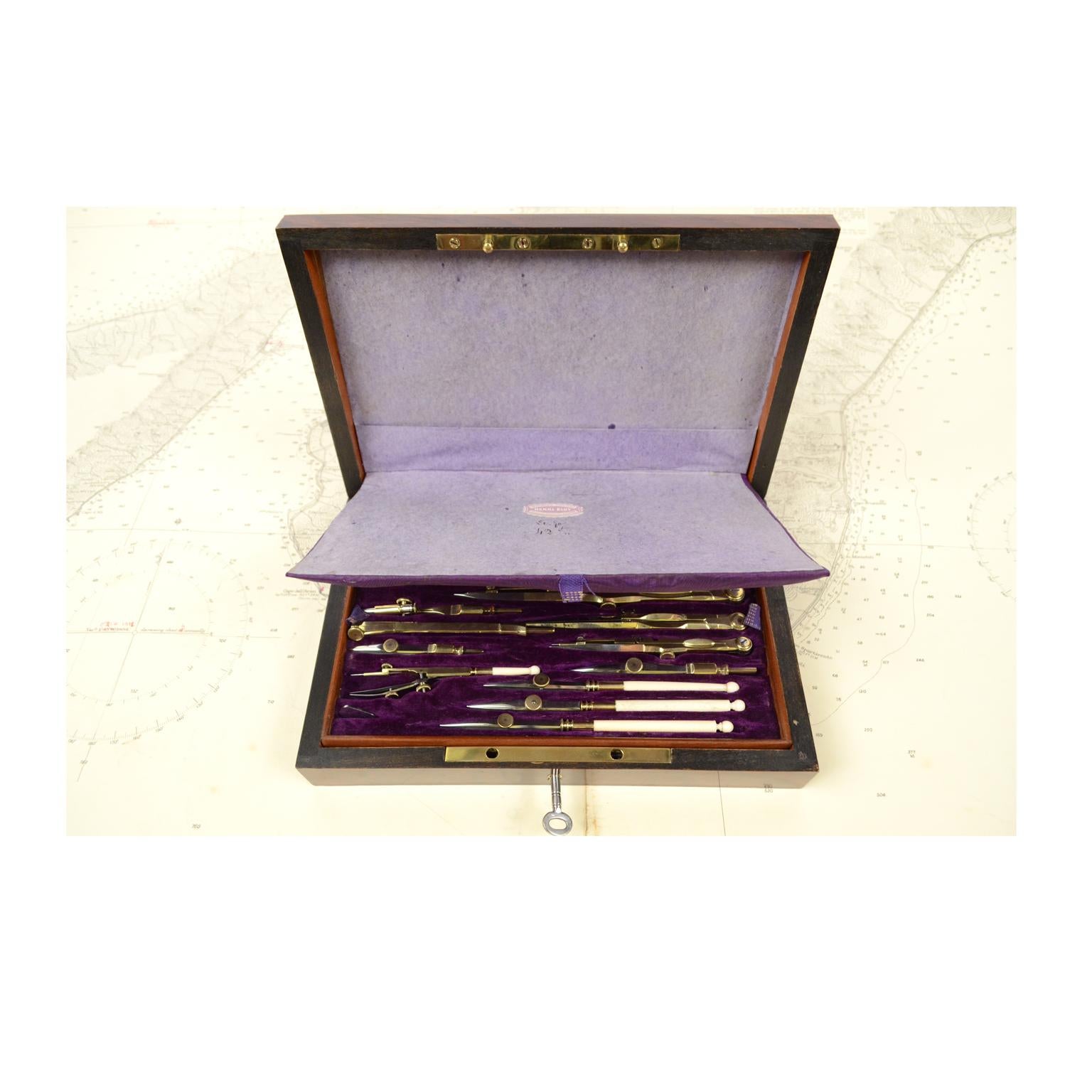 Elegant box of compasses made in the mid-19th century. Wooden box with brass hinges, complete with key. At the center of the lid there is a brass medallion diamond-shaped engraved with the name of the owner L. Lemire. Inside the box there are