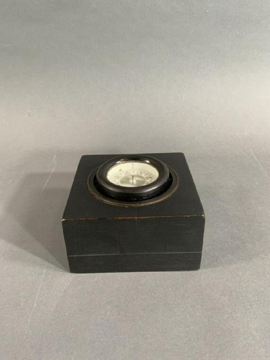 Small gimballed boat compass by Wilcox Crittenden of Connecticut. Flush mounted into a custom wood box.

Overall dimensions: Weight is 2 pounds. 3