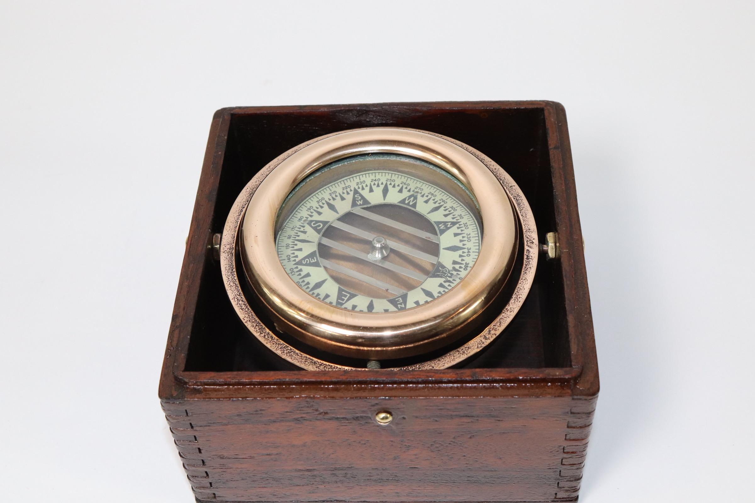 Boxed brass boat compass with gimbaled compass from Wilcox Crittendon of Connecticut. Varnished box with highly polished compass. Weight is 3 pounds.