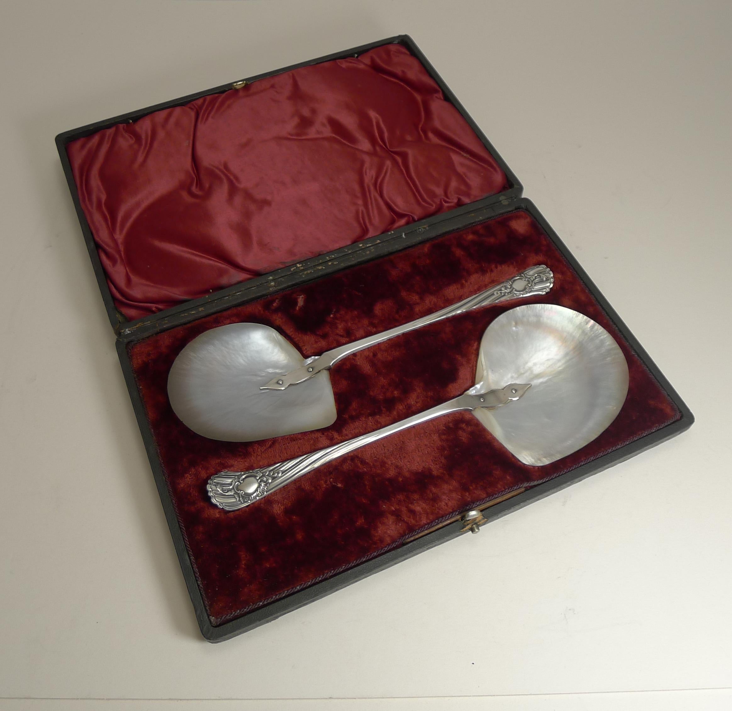 Truly magnificent to find a pair of these wonderful large Caviar serving spoons complete in their original Victorian presentation case.

The handles are made from English silver plate signed by the top-notch silversmith, James Dixon. They are also