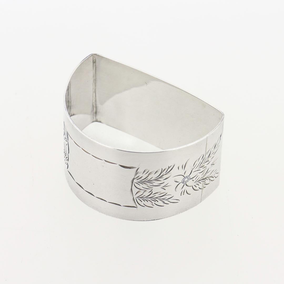 A fine vintage English napkin ring.

In sterling silver.

Marked for John Rose of Birmingham and 1969.

Of a semi-circular shape with bright-cut decoration to all sides.

Together with a Hamilton & Inches retailer's box.

Simply a wonderful English