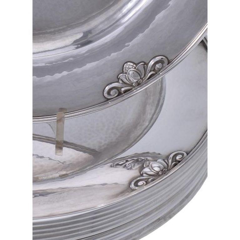 This is a set of ten matching sterling silver Georg Jensen hammered charger plates in the Acorn pattern, design #642A by Johan Rohde.
Each plate measures 11? (28cm) in diameter.
Each set of ten comes in an original Georg Jensen fitted mahogany box