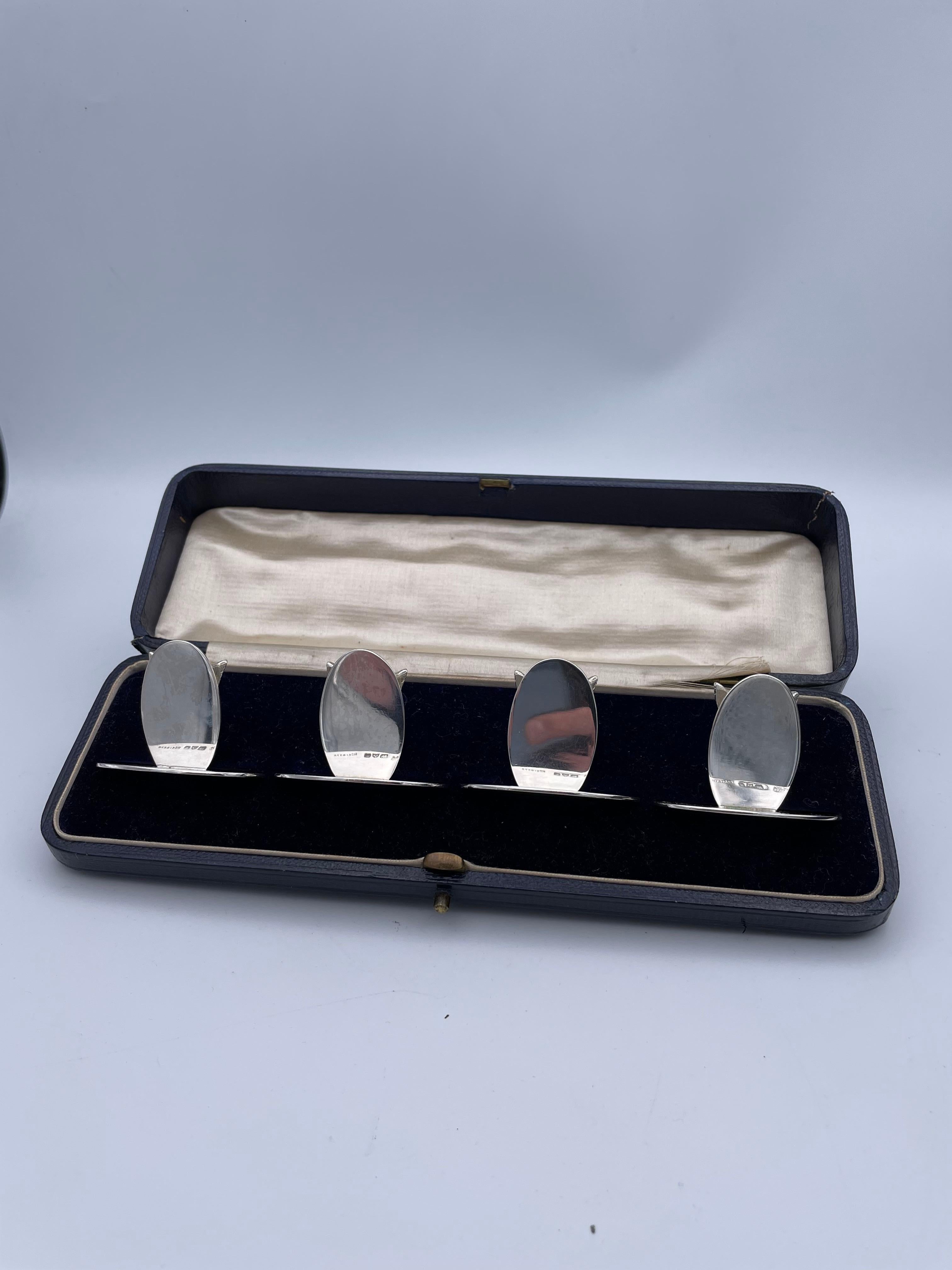 Fabulous set of four sterling silver figural fox head place card holders. Large size and very heavy gauge silver. Each three-dimensional well-detailed fox head is set with cabochon amethyst eyes. Oval base, and oval stand in back of the fox head. 1