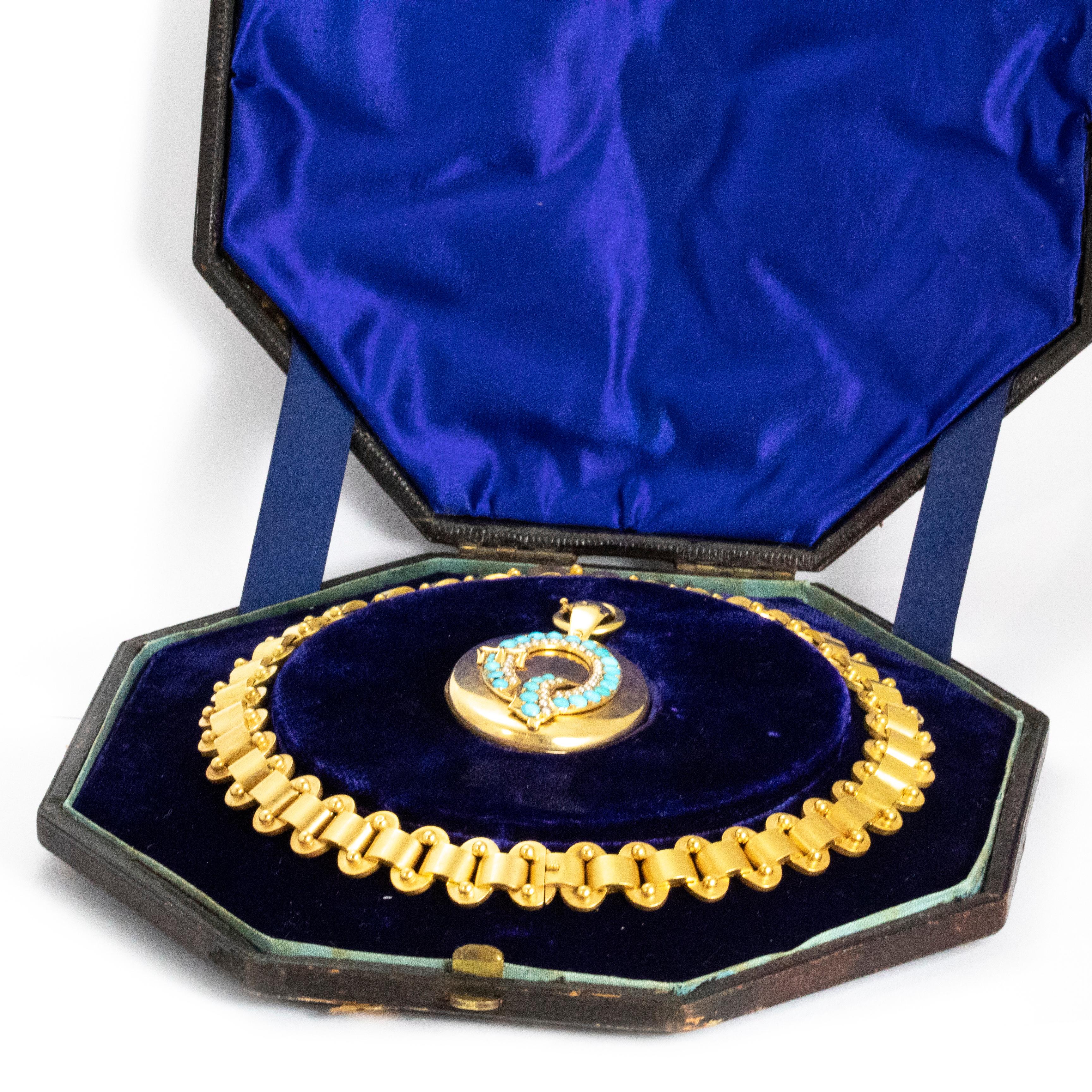 An exceptional antique Victorian collar and locket set in their fantastic original plush velvet octagonal box. The locket is inlaid with a letter Q lined with turquoise cabochons and pearls, and set with a fine buckle motif. Buckles in Victorian