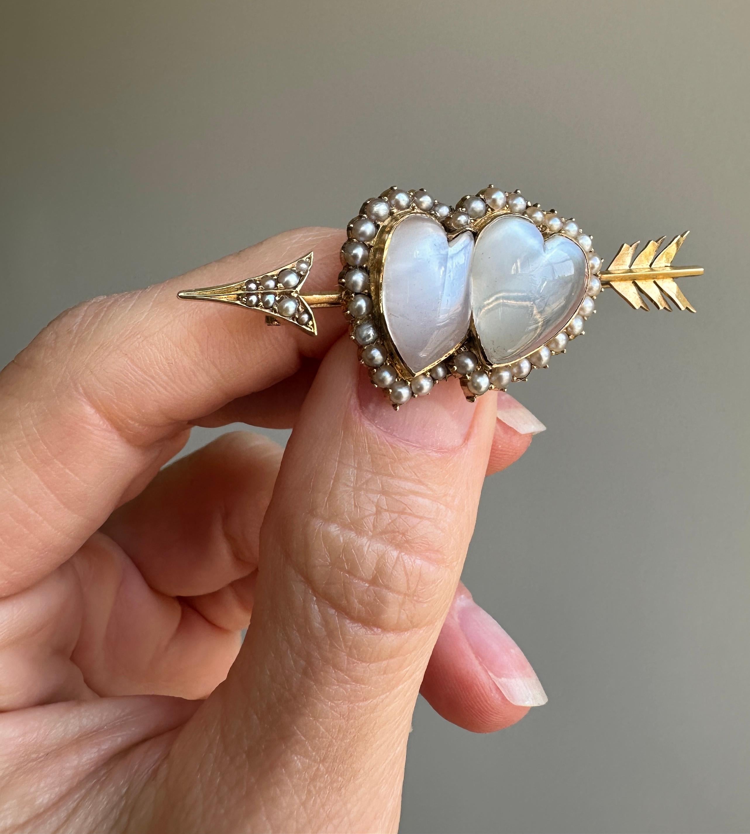 A pair of late Victorian diamond moonstone sweethearts nestled side-by-side framed by lustrous half pearls and Cupid's golden arrow. Comes with the original box as shown. Sweet as can be.

 

Measurements: 2 1/8