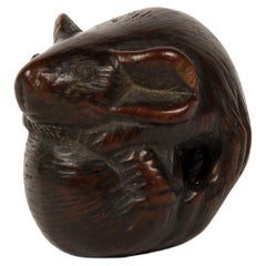 Boxwood nestuke in the form of a curled up mouse forming almost a pearl