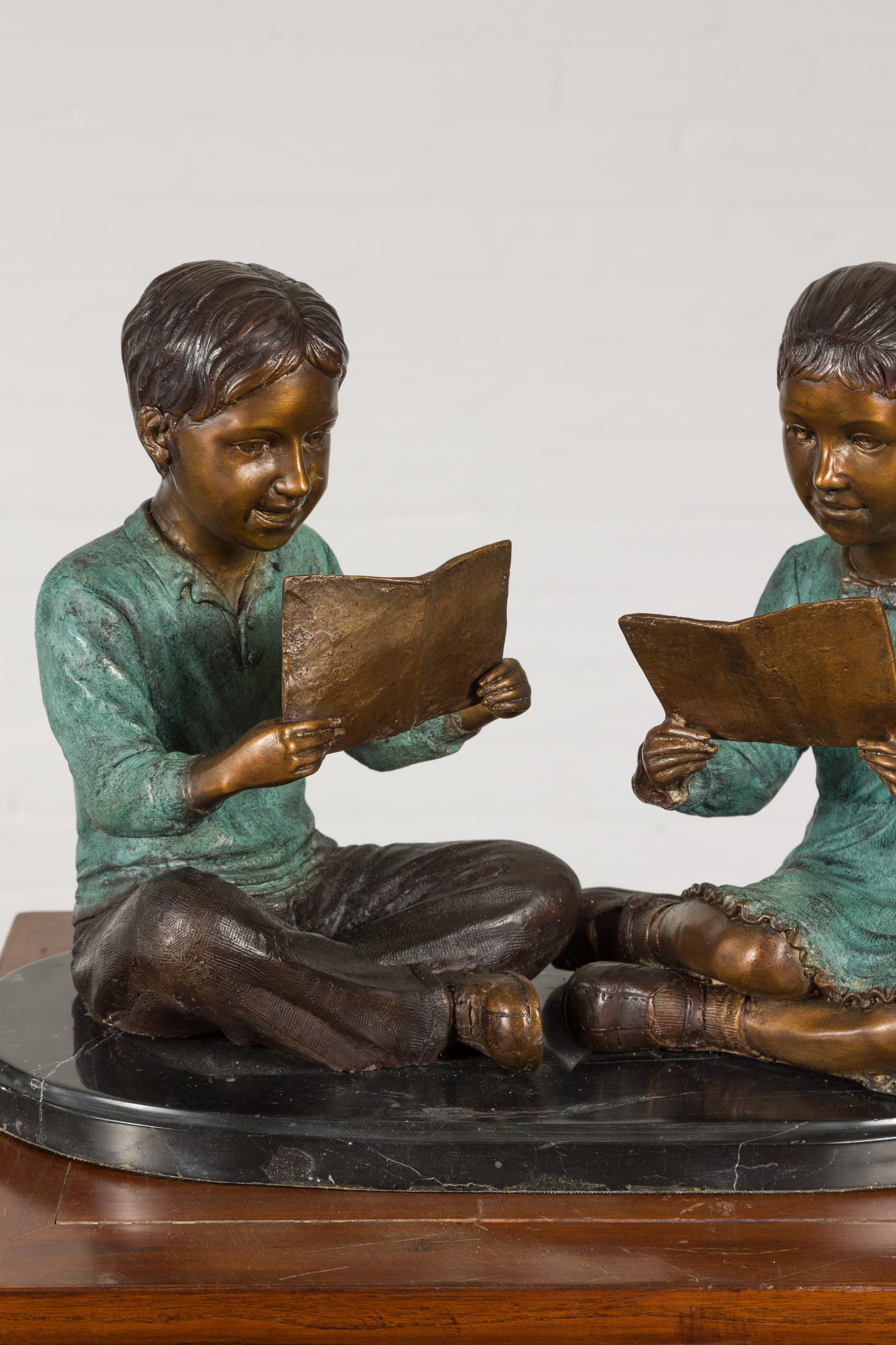 Patinated Bronze Sculpture of Children Reading For Sale