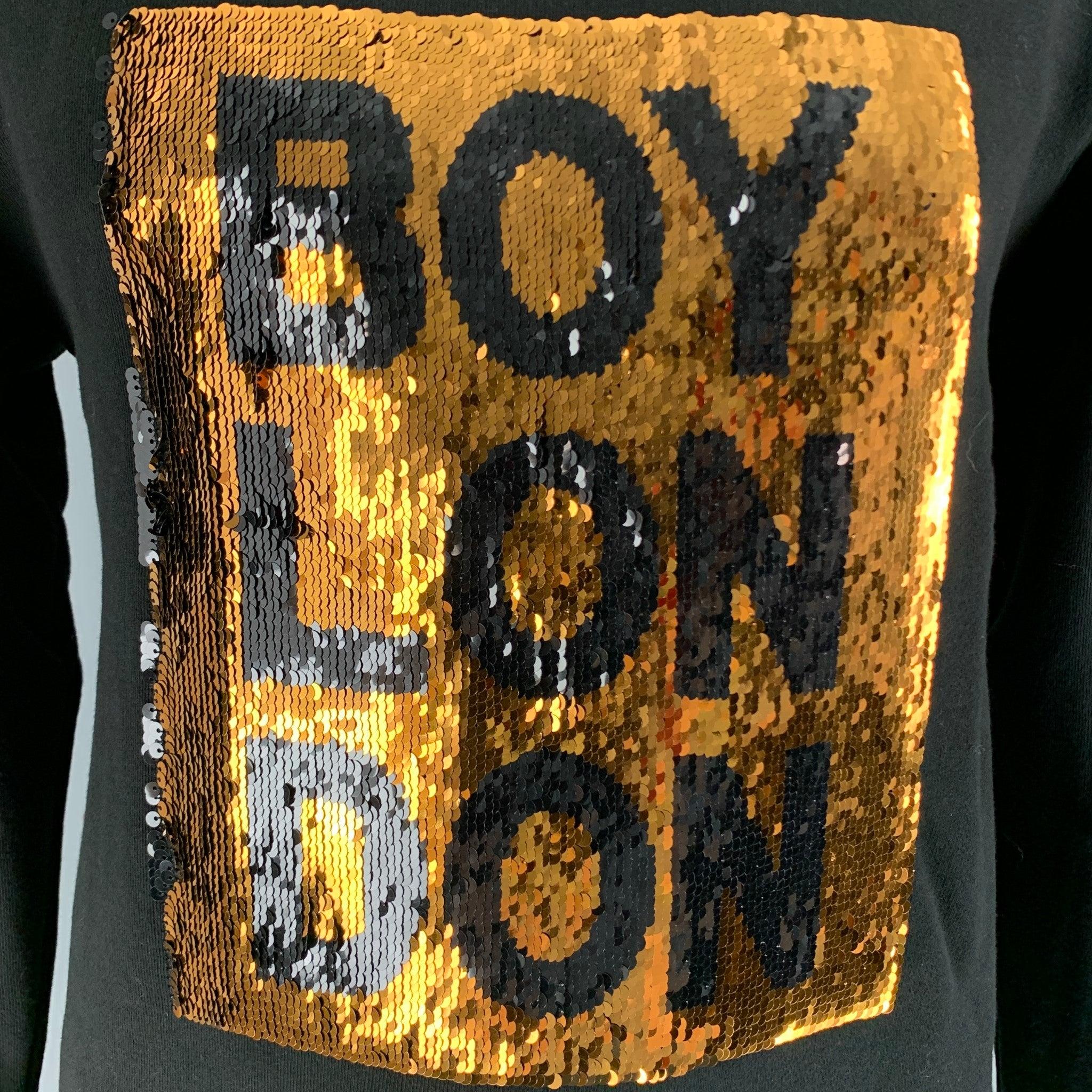 BOY LONDON Sweatshirt comes in a black cotton french terry knit material, with a crewneck, a sequined embellishment at front, and ribbed cuffs and hem.Excellent Pre-Owned Condition. 

Marked:   L 

Measurements: 
 
Shoulder: 24 inches Chest: 48