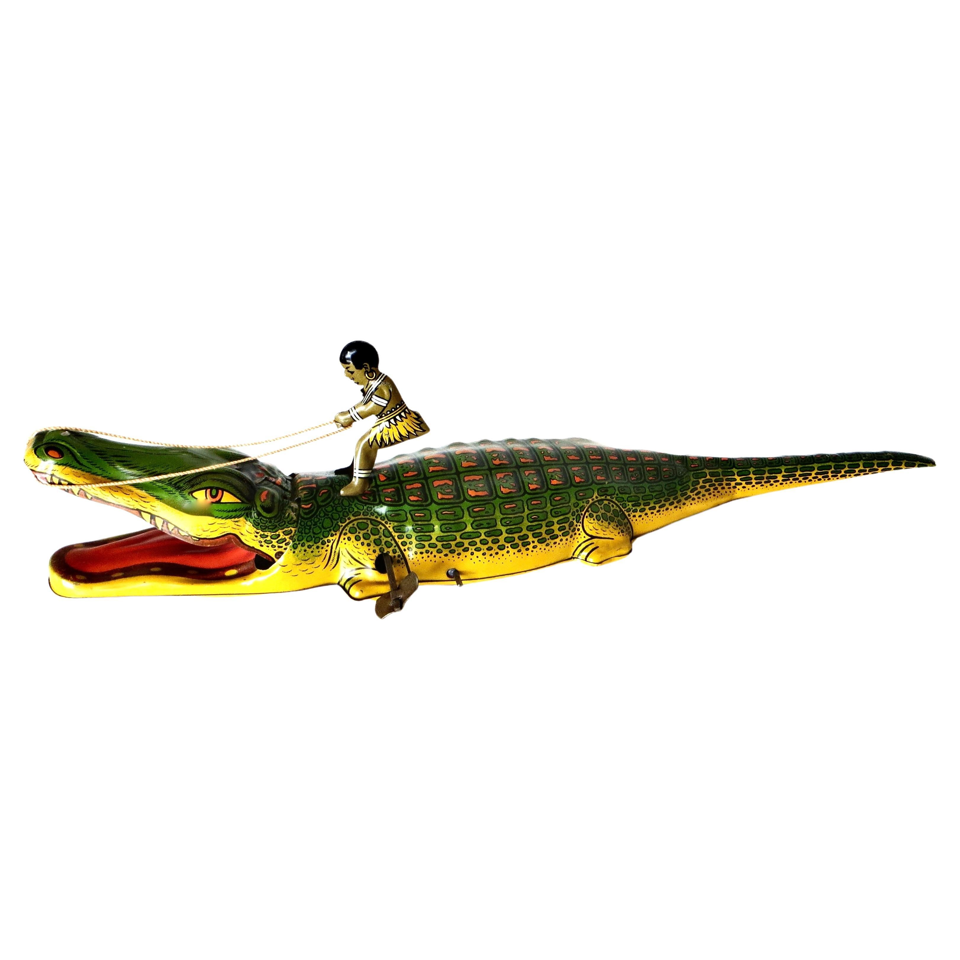 Jouet à remonter le manche vintage "Boy Riding An Alligator" de J. Chein Co, N.J., vers 1935