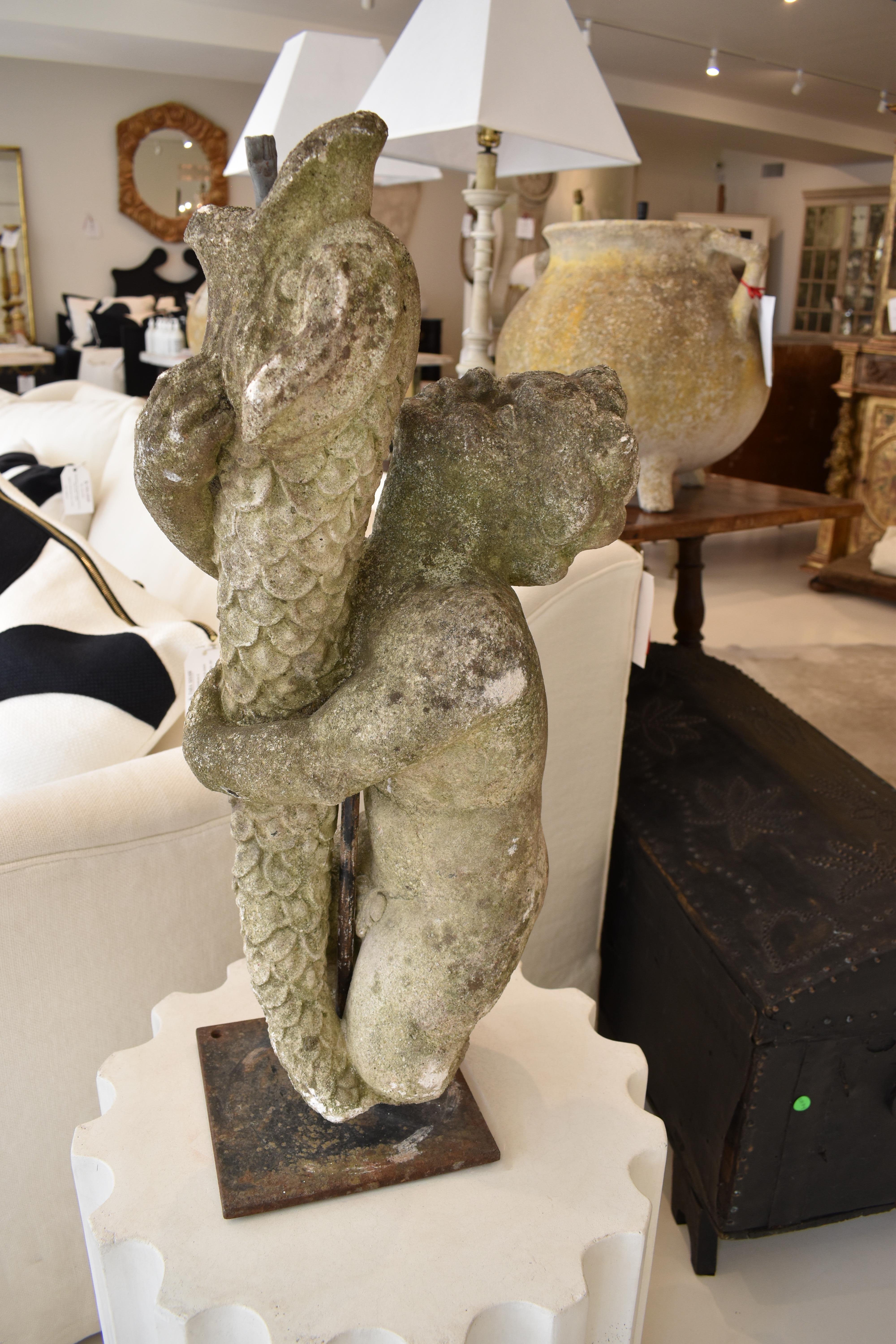 Possibly based on the old tale of the boy who caught a big fish, brought it home to keep as a pet, but returned it to the wild so it could be with his fish friends; this lovely statue would look great in your garden. It features a cherub or young