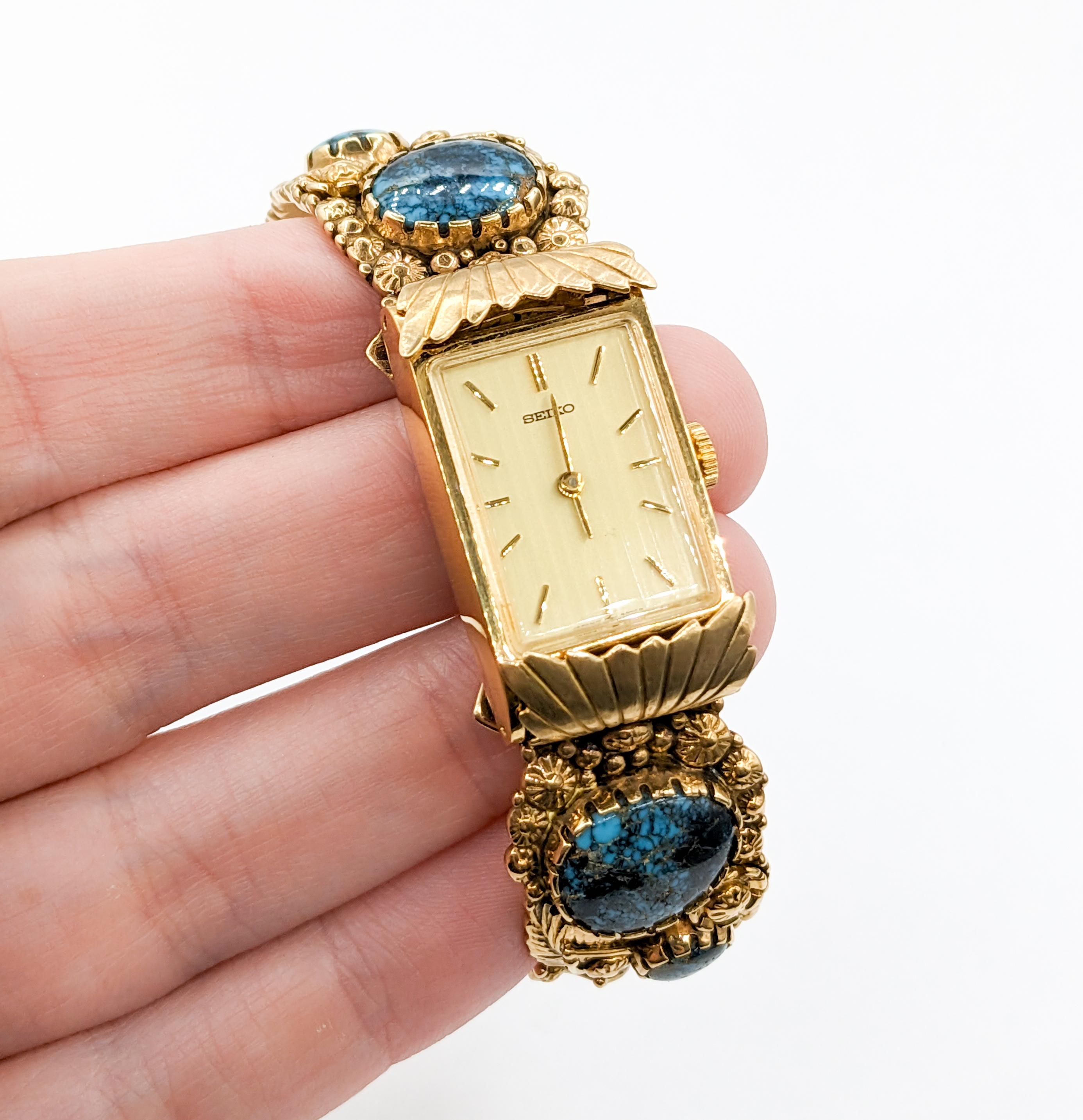 Boyd Tsosie Turquoise & 14K Gold Cuff with Seiko Timepiece

Experience timeless elegance with this Boyd Tsosie bangle. Meticulously crafted in 14k yellow gold, it showcases vibrant turquoise embellishments paired with the reliable precision of a