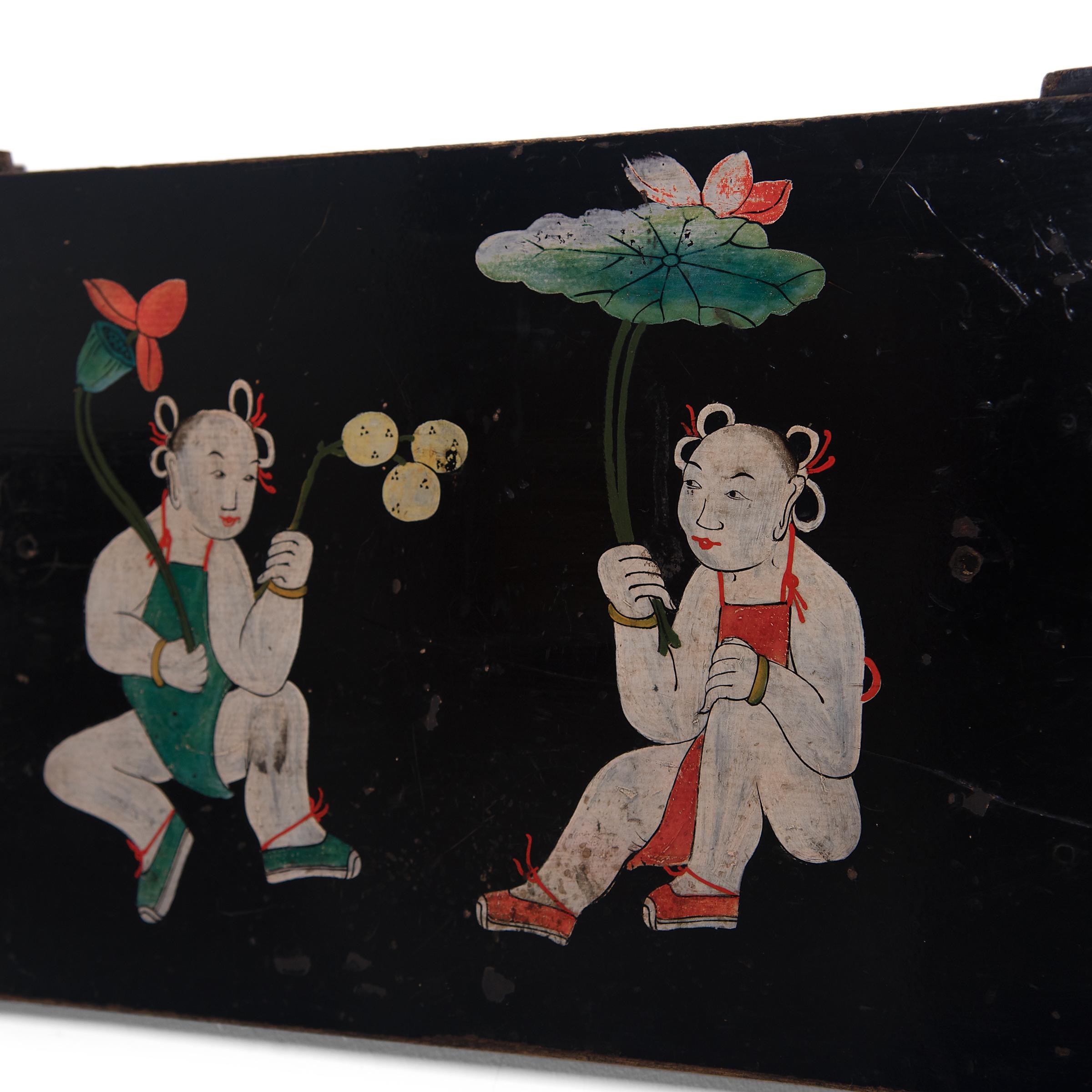 This folk hand painted panel, laden with meaning, was originally an interior painted panel of a large storage cabinet. The panel is painted with a scene of two young boys in traditional aprons, a motif commonly referred to as 