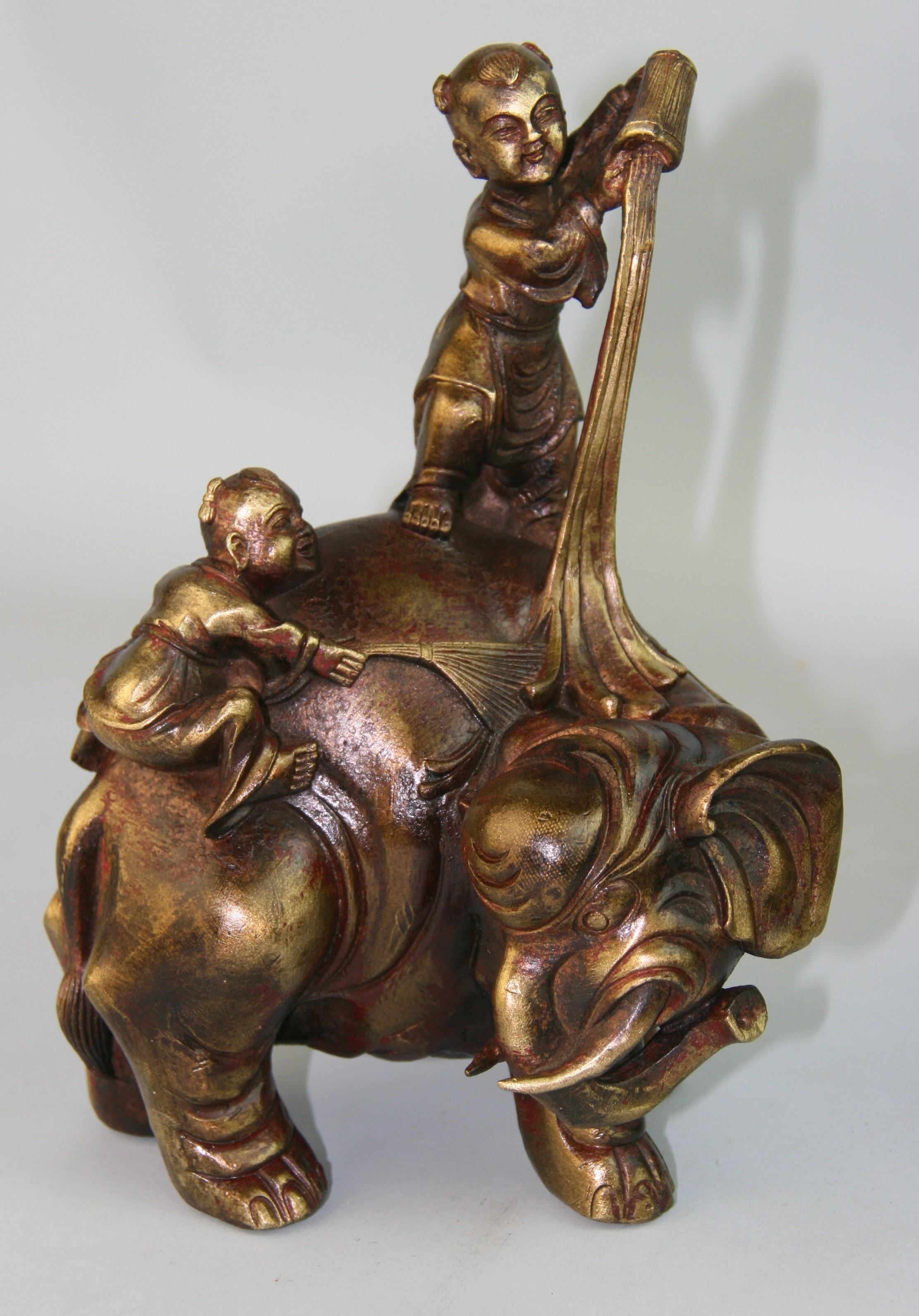 1473 Solid bronze sculpture with fine detailing of two boys washing an elephant. Remnants of red polychrome.