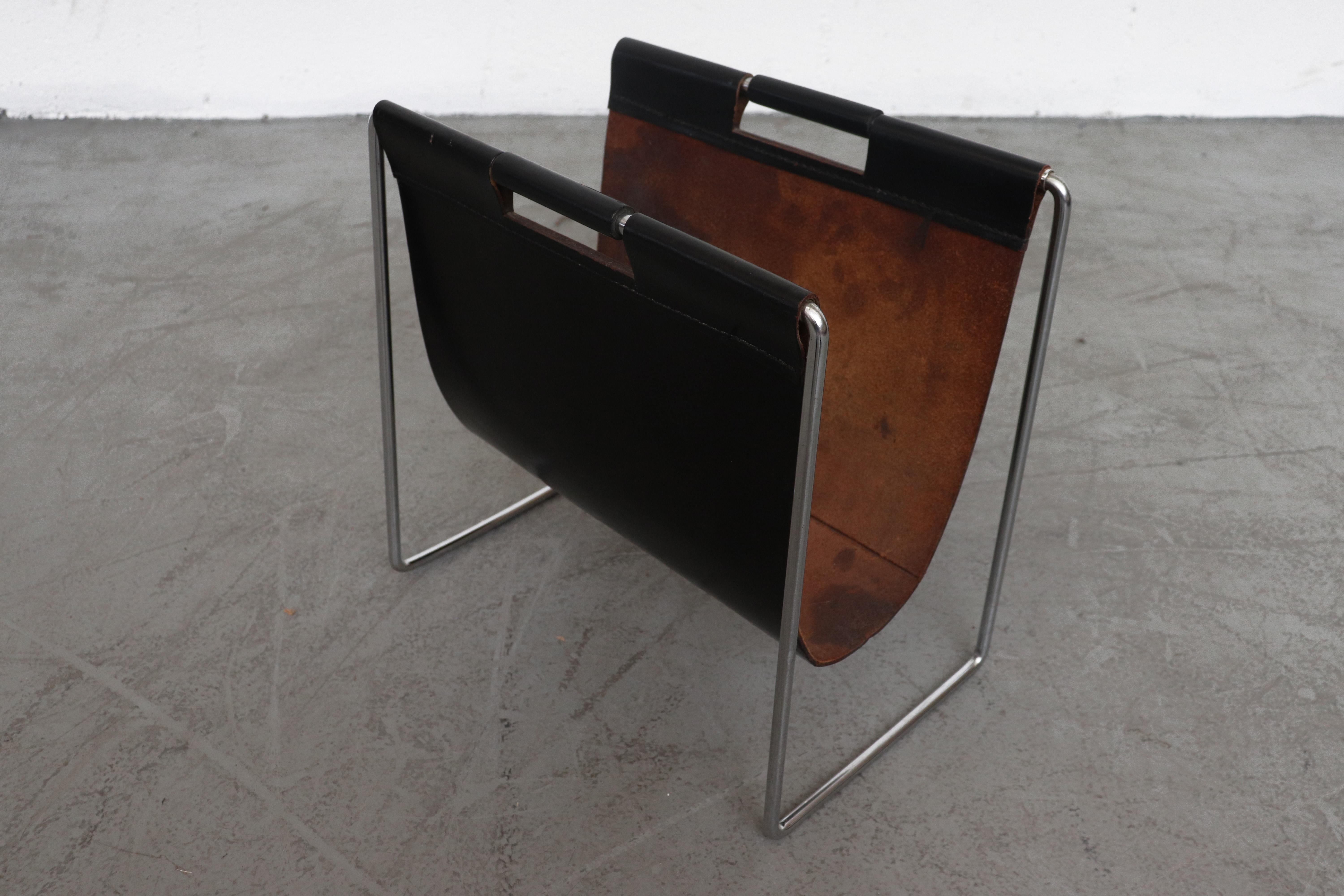 Brabantia black leather magazine stand with chrome legs and ebonized handle grips. In original condition with some signs of visual wear consistent with age and use. Other colors available, listed separately (LU922412846202).