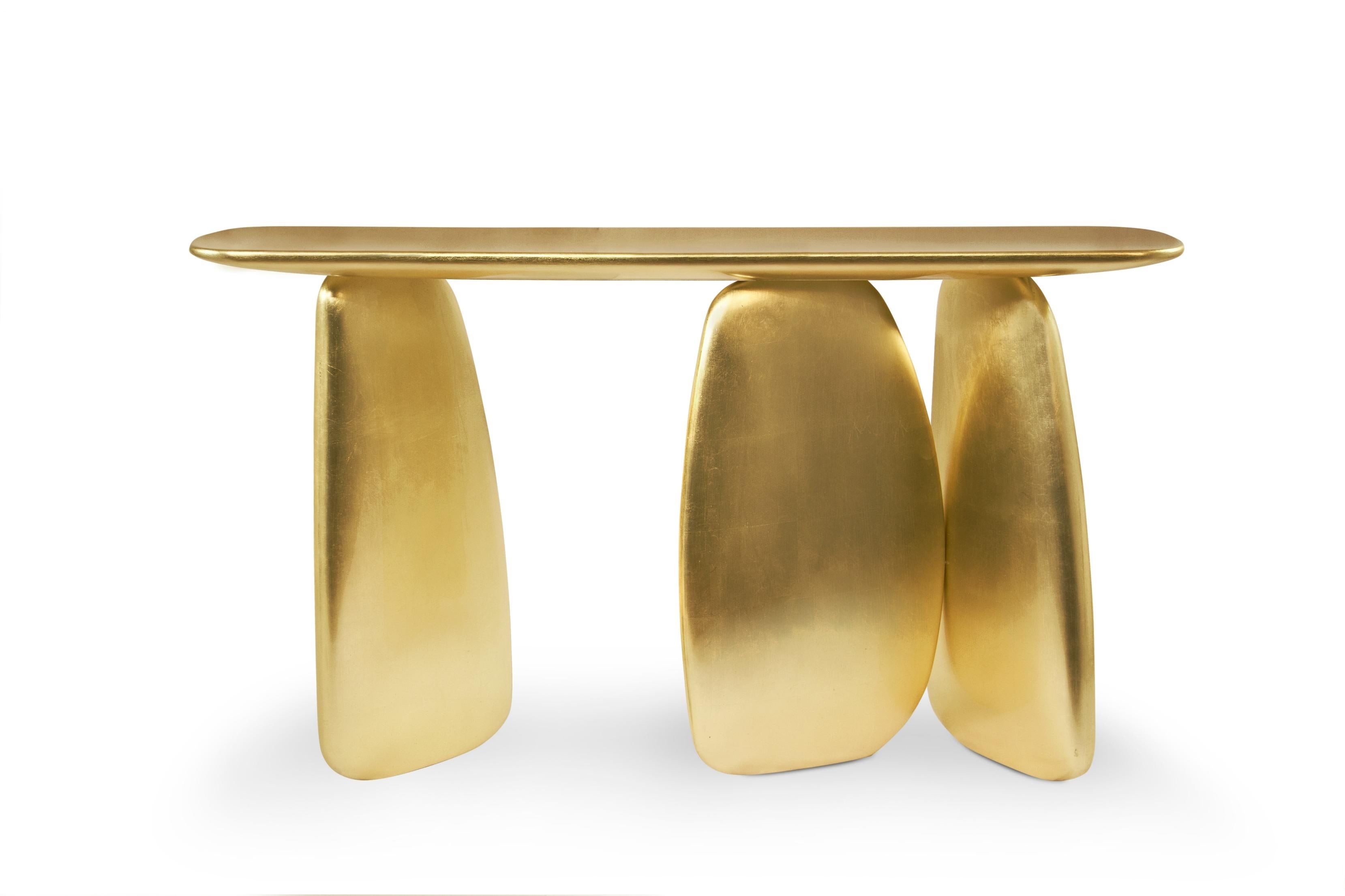 Dolmens are ancient stone monuments from the Neolithic period. These unique structures were the inspiration behind the ARDARA Console Table. With a finish in gold leaf with a gloss varnish, this console table will give a unique twist to any interior