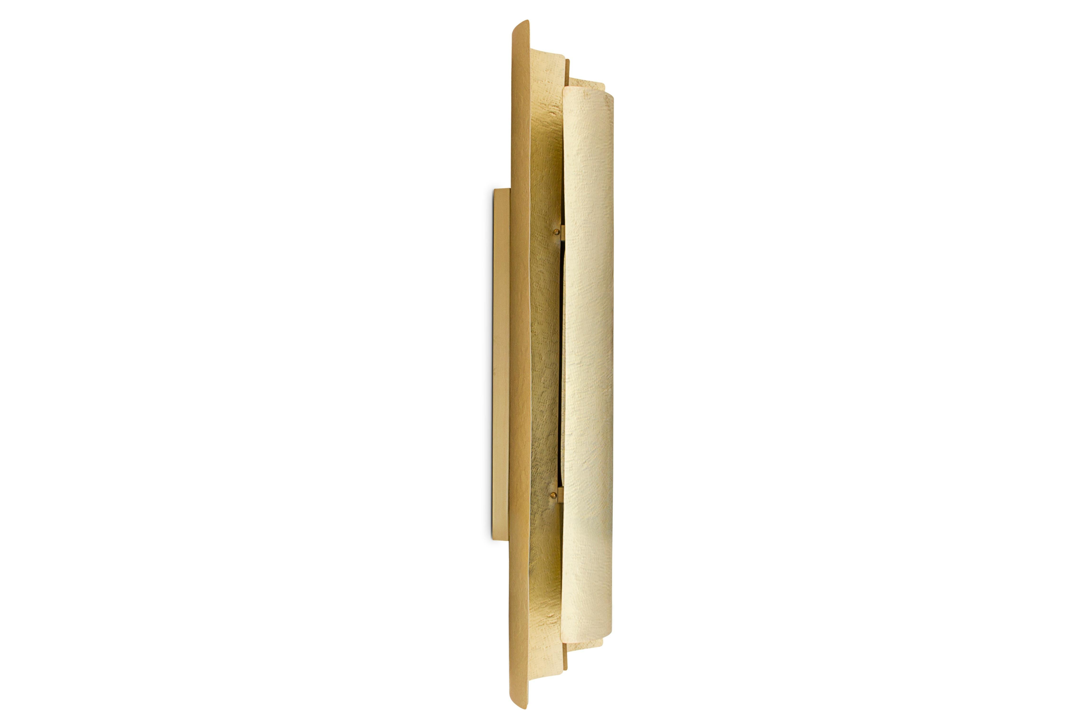 Aurum is the Latin word for gold. This imposing metal also named a contemporary lighting piece made of matte hammered brass. With a unique design, Aurum wall light will bring comfort in the darkest nights with its warm yet sensitive light. This