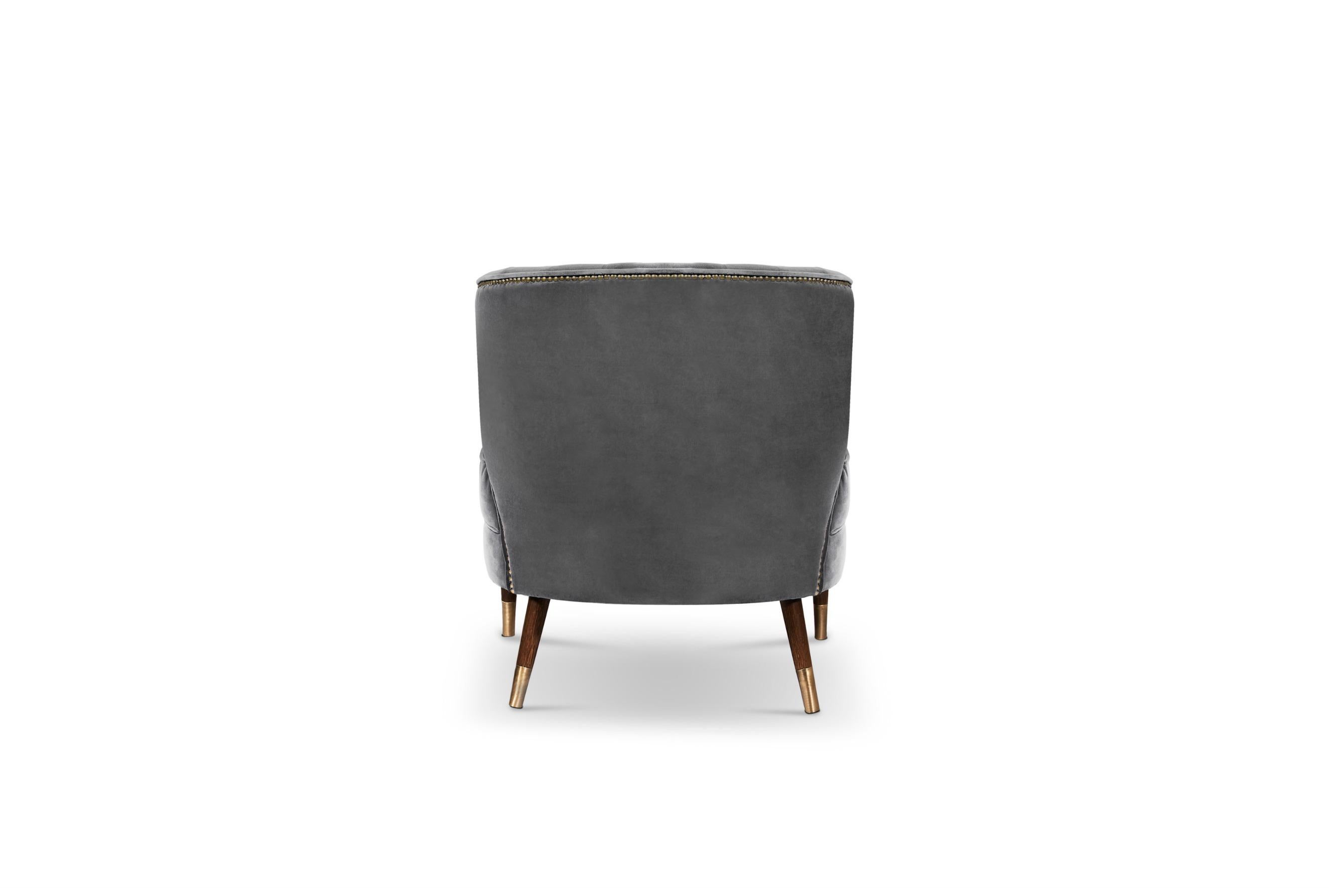 Ibis are beautiful birds known for their long slim legs. Just like Ibis armchair, an elegant seating solution. Upholstered in cotton velvet, this accent chair with an aged brass nailheads trim will be the focal point of any living room