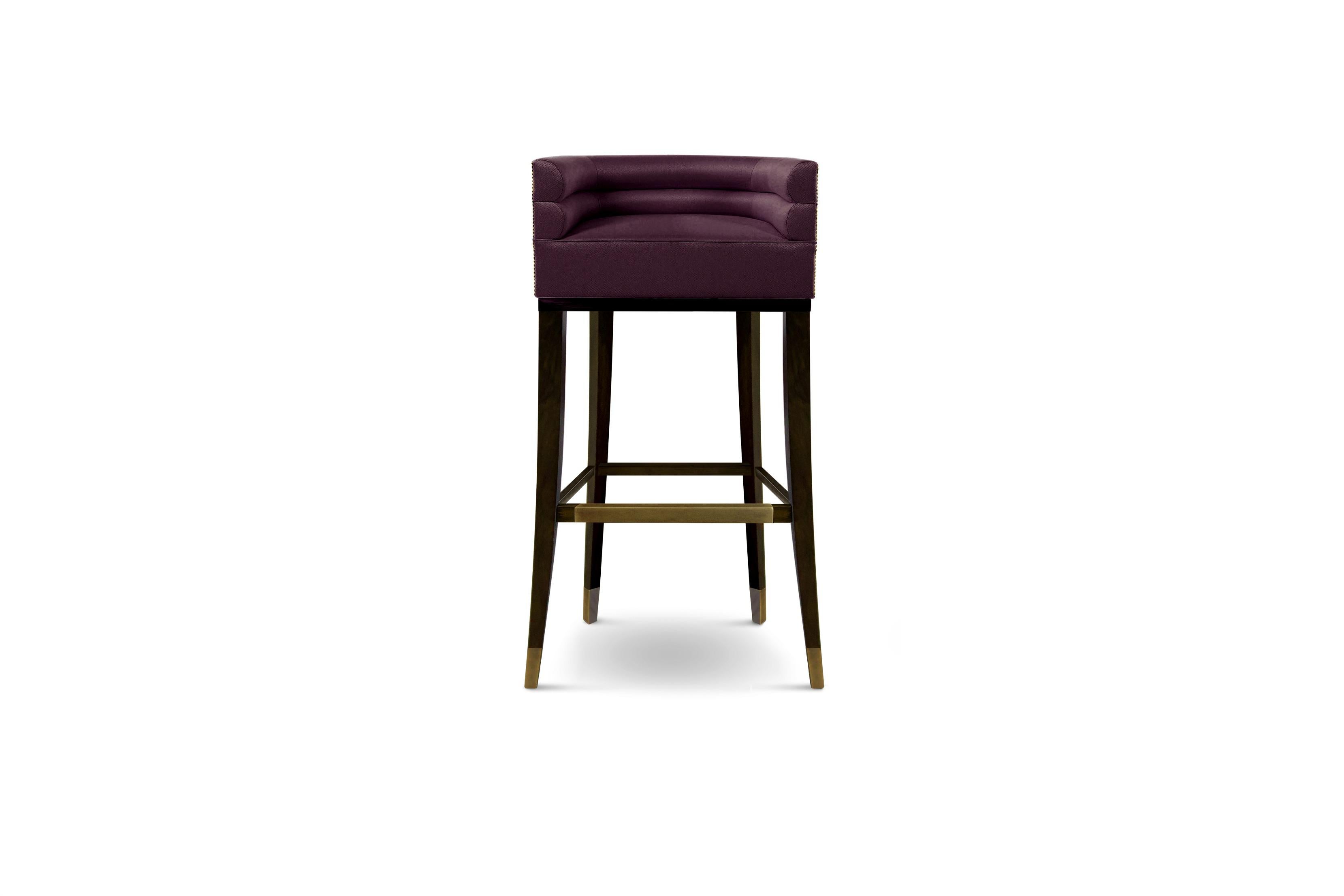 Maa is the language spoken by the Maasai tribe, known for its harmonious dialect. MAA Bar Chair pays tribute to it. This channel-tufted bar stool with back features a nailhead trim that wraps around the piece and legs in ash with walnut stain matte