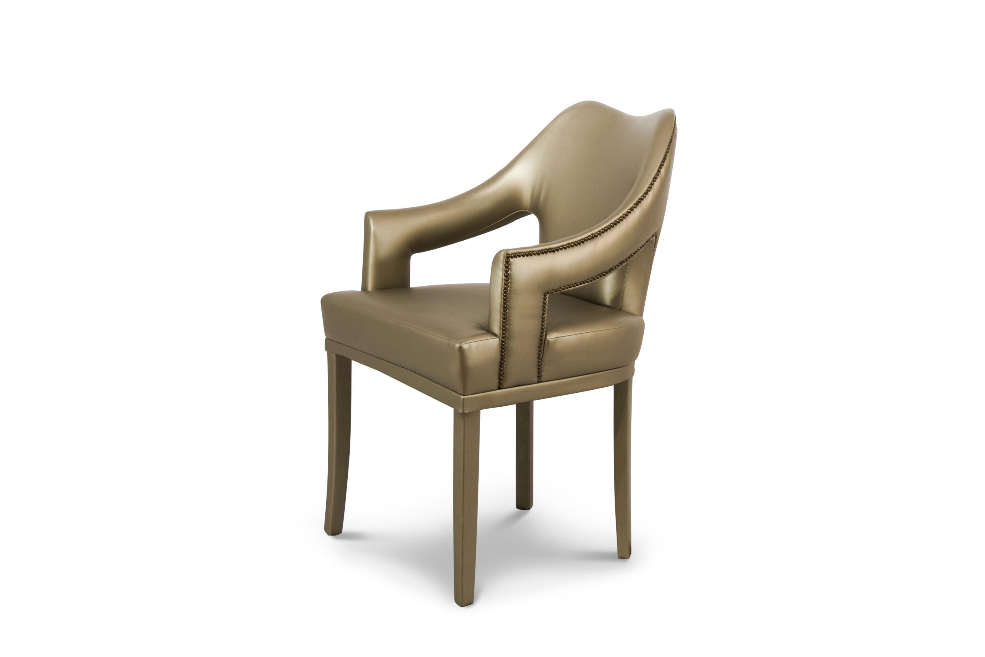 Symbol of knowledge and rebirth, Nº20 Dining Chair was raised through a long journey of 24 prototypes. This fabric chair, fully upholstered in twill, features a nailhead trim that adds subtle sophistication. Full of strength and determination, this