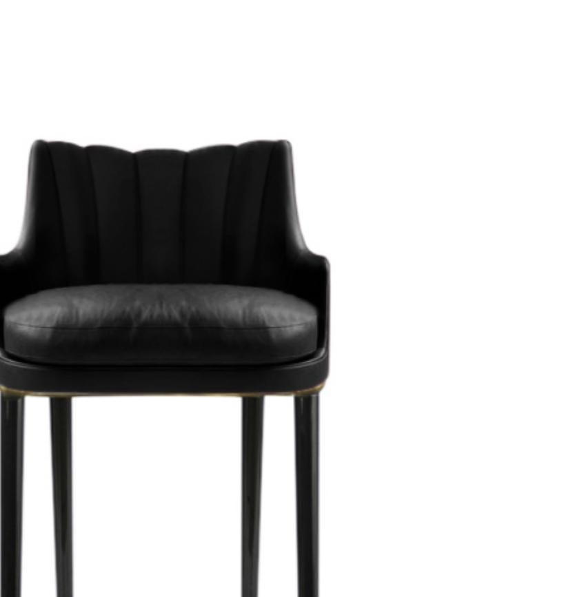 PLUM is a throwback to the past with a contemporary touch. With glossy black lacquered legs, this fully upholstered chair celebrates luxury and opulence highlighted by the real leather that surrounds it. Place it in a bar design and this bar stool