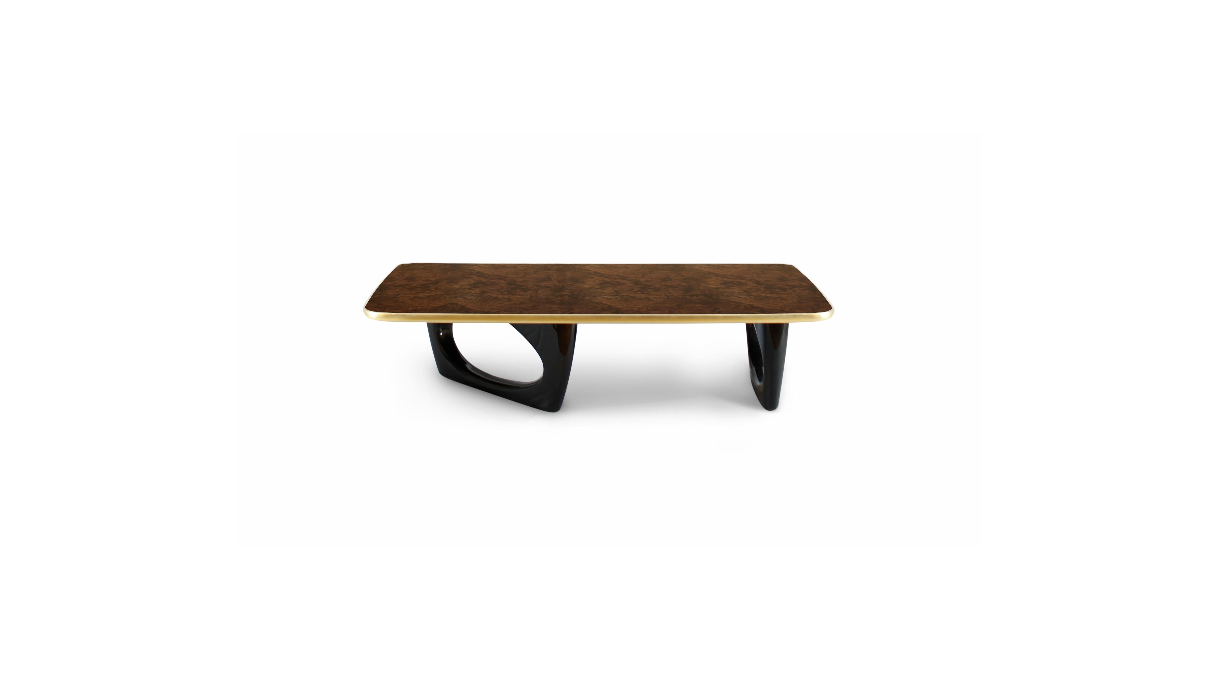 From the legend of Robin Hood arises Sherwood center table. A rectangular coffee table with a base in wood with black lacquer & a top in glossy walnut root veneer with gold leaf frame. This wood coffee table is ideal for Mid-Century Modern