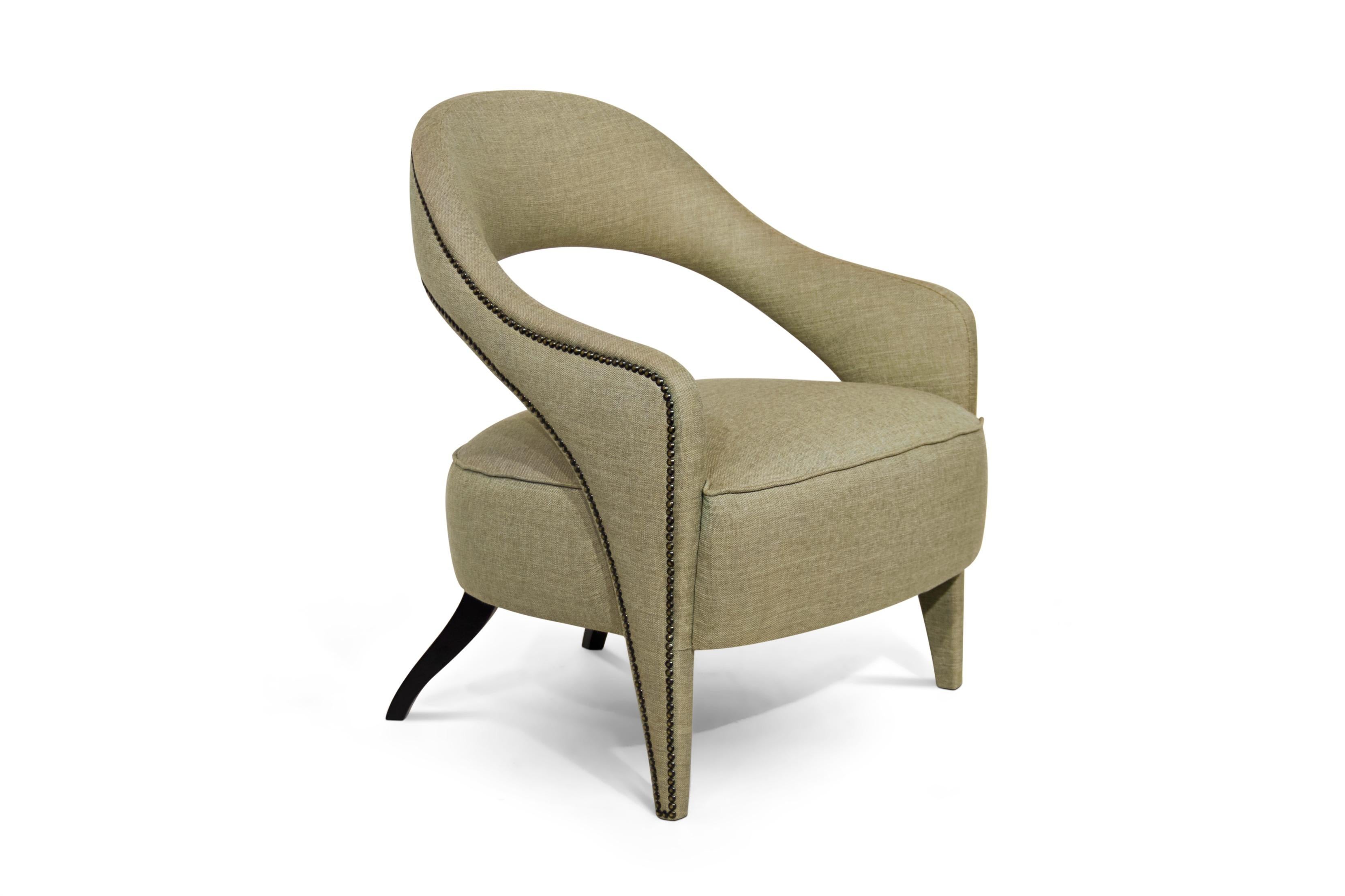 In Roman mythology, Tellus is the goddess of the Earth. Tellus lounge chair honors its deity aura. The twill fabric, nailhead trim and the back legs in matte lacquered add subtle sophistication, making this fabric chair an elegant piece able to fit