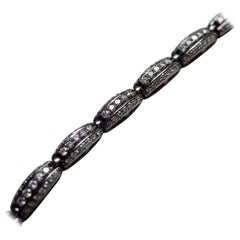 Pulsera de eslabones geométricos en oro blanco bruñido y diamantes