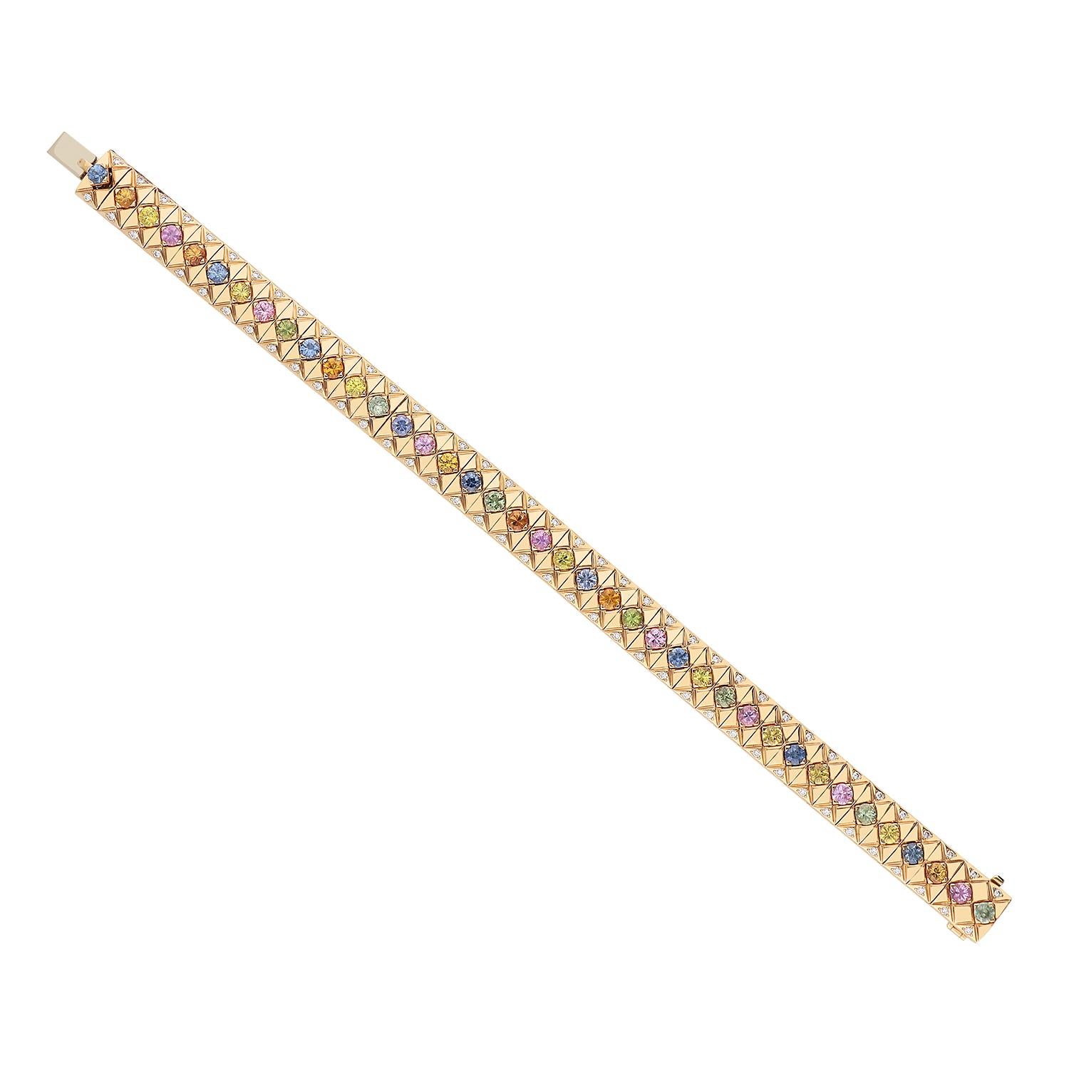 A magnificent 18kt rose gold bracelet weighing a total of 39.30 grams with multi-color brilliant-cut sapphires for 5.56 carats, set on flat tips. On either side of each sapphire are brilliant-cut diamonds, color G SI clarity, totaling 0.61 carats.