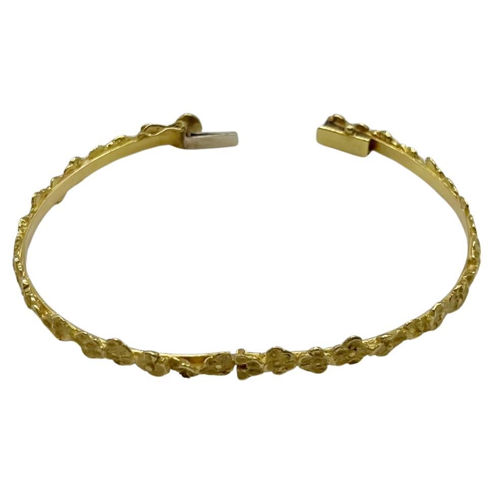 Bracciale semirigido artigianale in oro giallo 18 kt.