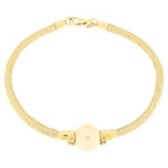 Bracciale semirigido in oro giallo con diamanti e perla oro