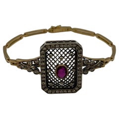Bracciale stile rétro in oro giallo e argento con brillanti e rubino centrale