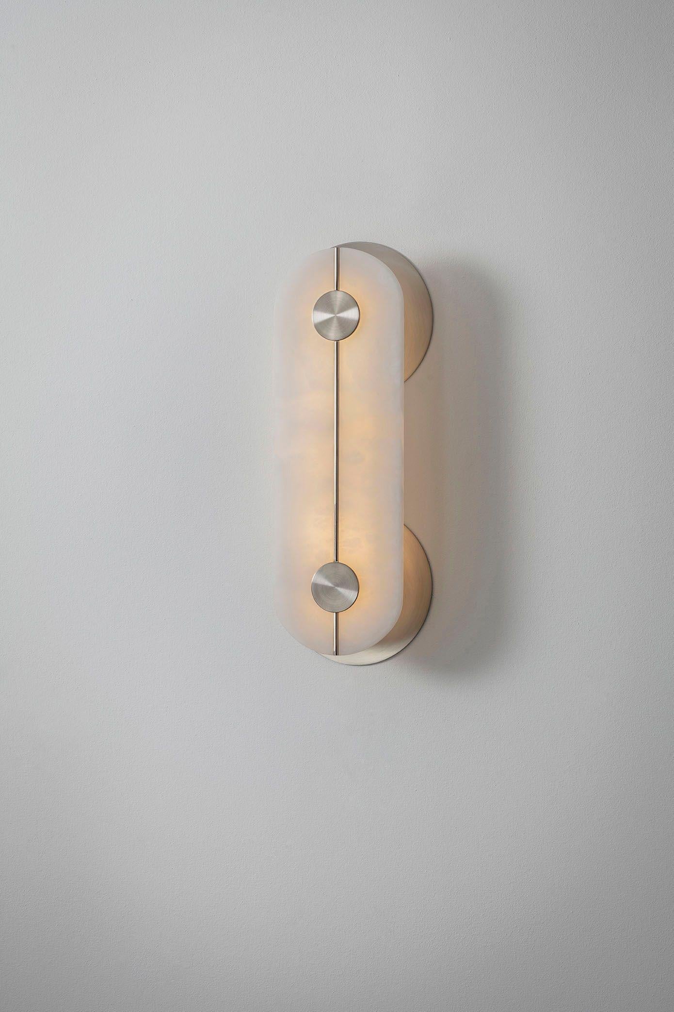 Brace wall light nickel small by Bert Frank
Dimensions: 7 x 16 x H 43 cm 
Materials: Nickel, Alabaster


All our lamps can be wired according to each country. If sold to the USA it will be wired for the USA for instance.

When Adam Yeats and