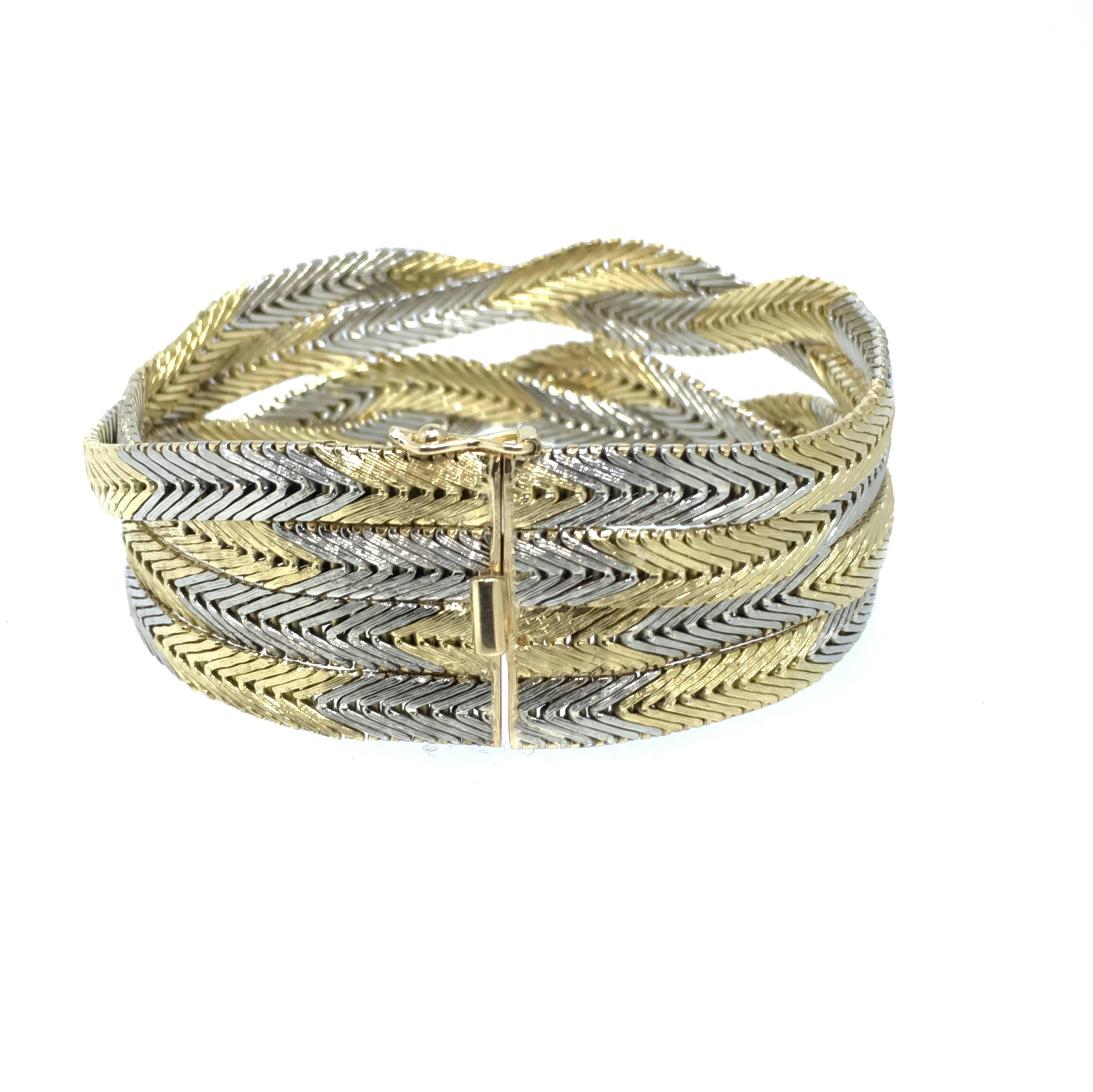 This Braided white and yellow gold bracelet has a soft weighty feel. Made in the seventies this 18 carat gold with has total weight of 76,8 grams. 
The Italian design and the specific surface treatment give this bracelet this special occurrence.
