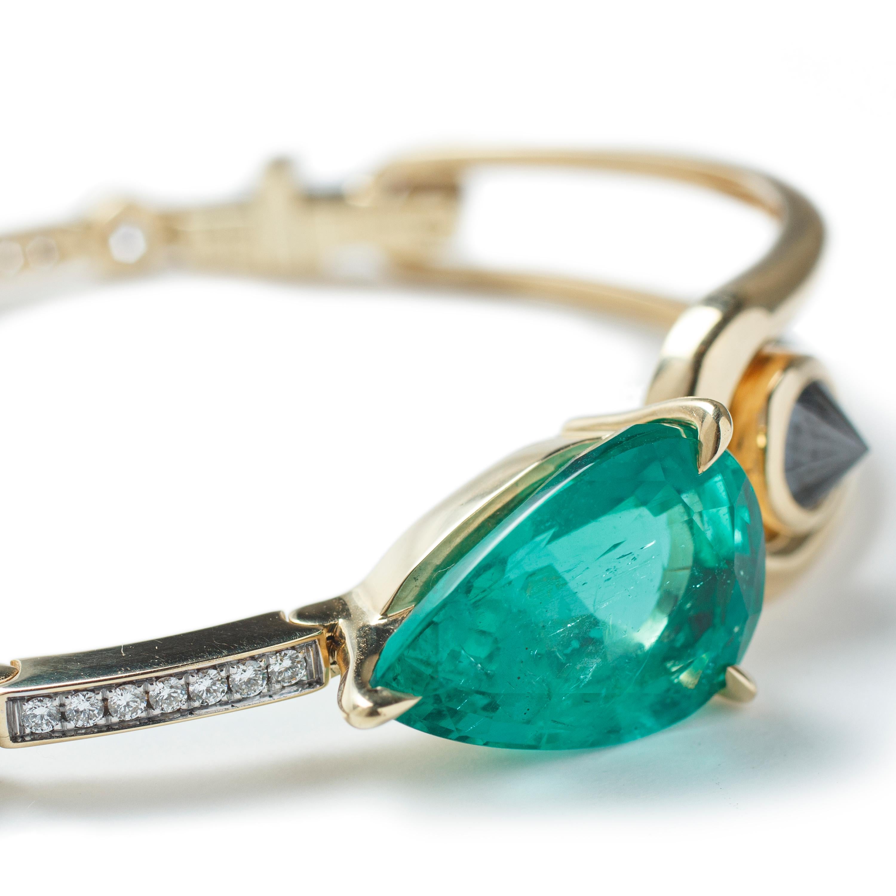 This 18k Yellow Gold hinged body Bracelet, features one Emerald in a pear faceted cut, along with Black and White Diamonds. 

This Bracelet has been exclusively designed by Ara Vartanian and was handcrafted in his Sao Paulo Atelier. For this