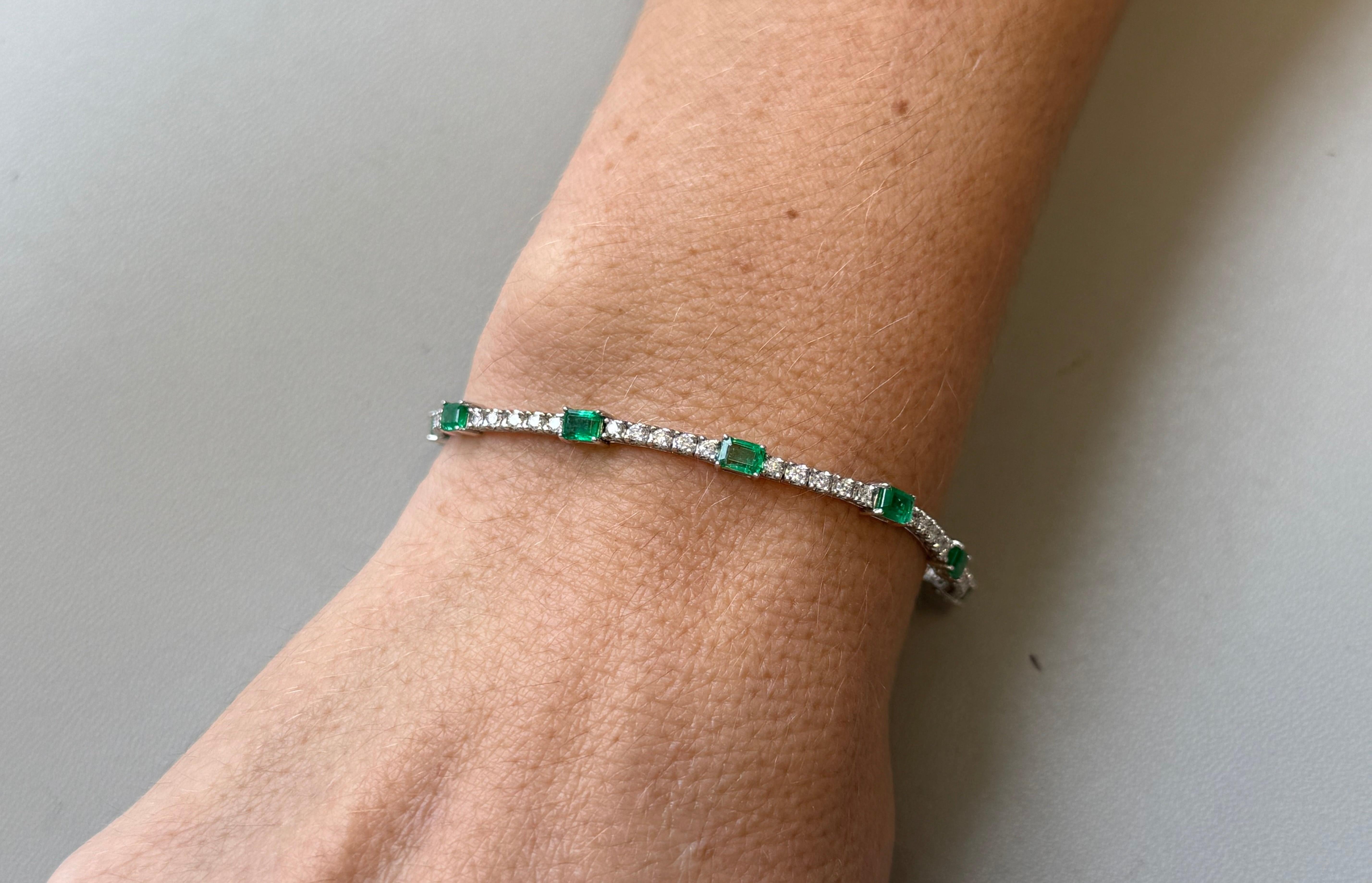 Timeless elegance meets vibrant beauty in this exquisitely crafted tennis bracelet. Fashioned from gleaming 18kt white gold, it features a captivating arrangement of 61 dazzling diamonds (1.10 carats total) and 10 richly colored emeralds (1.94