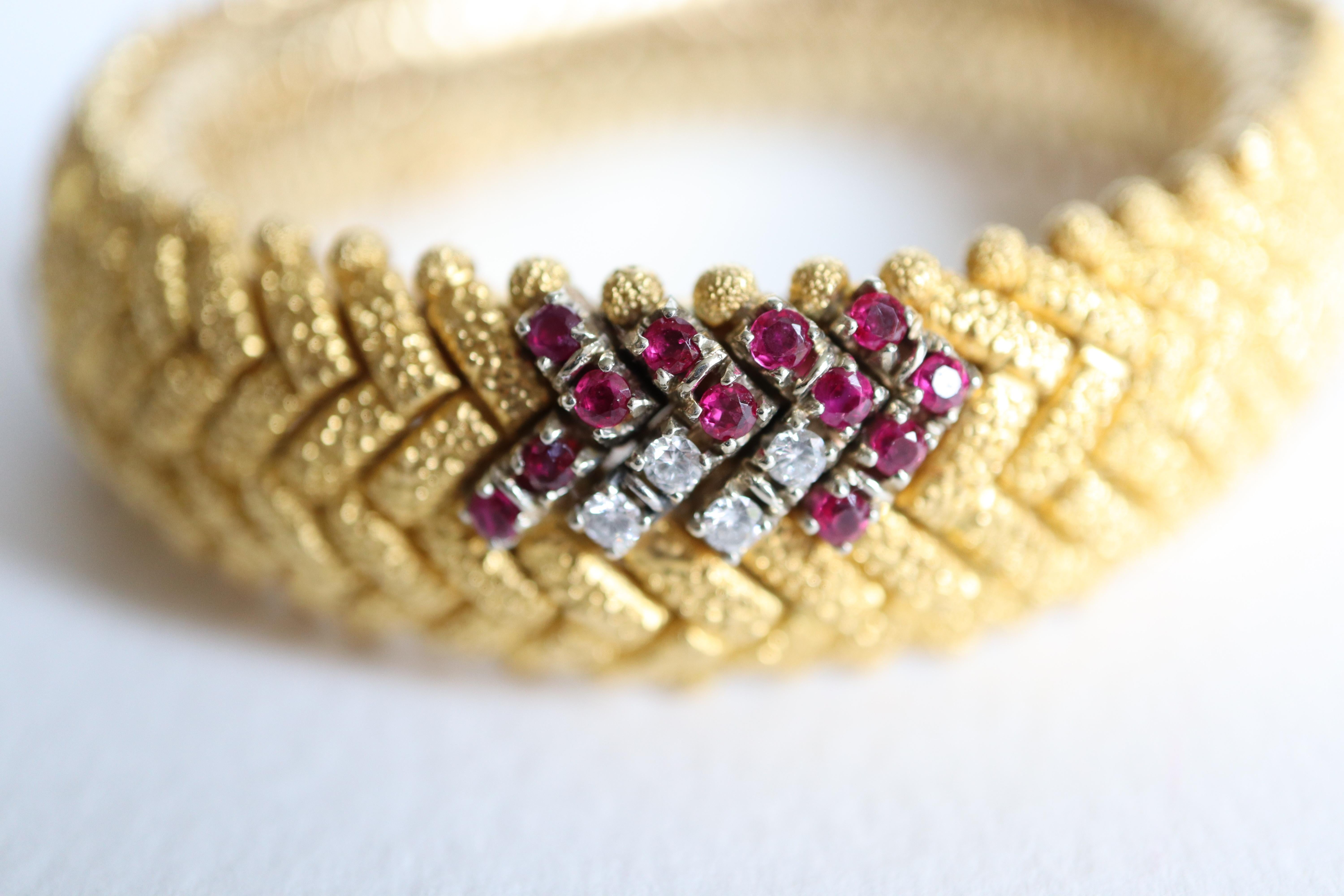 Bracelet circa 1960 in hammered Satin-brushed 18-karat yellow Gold and Ruby, flexible articulated Snake Link with geometric patterns including Four V-shaped Patterns setting twelve Rubies each, for one Carat, that is 4 carats of rubies for the 4