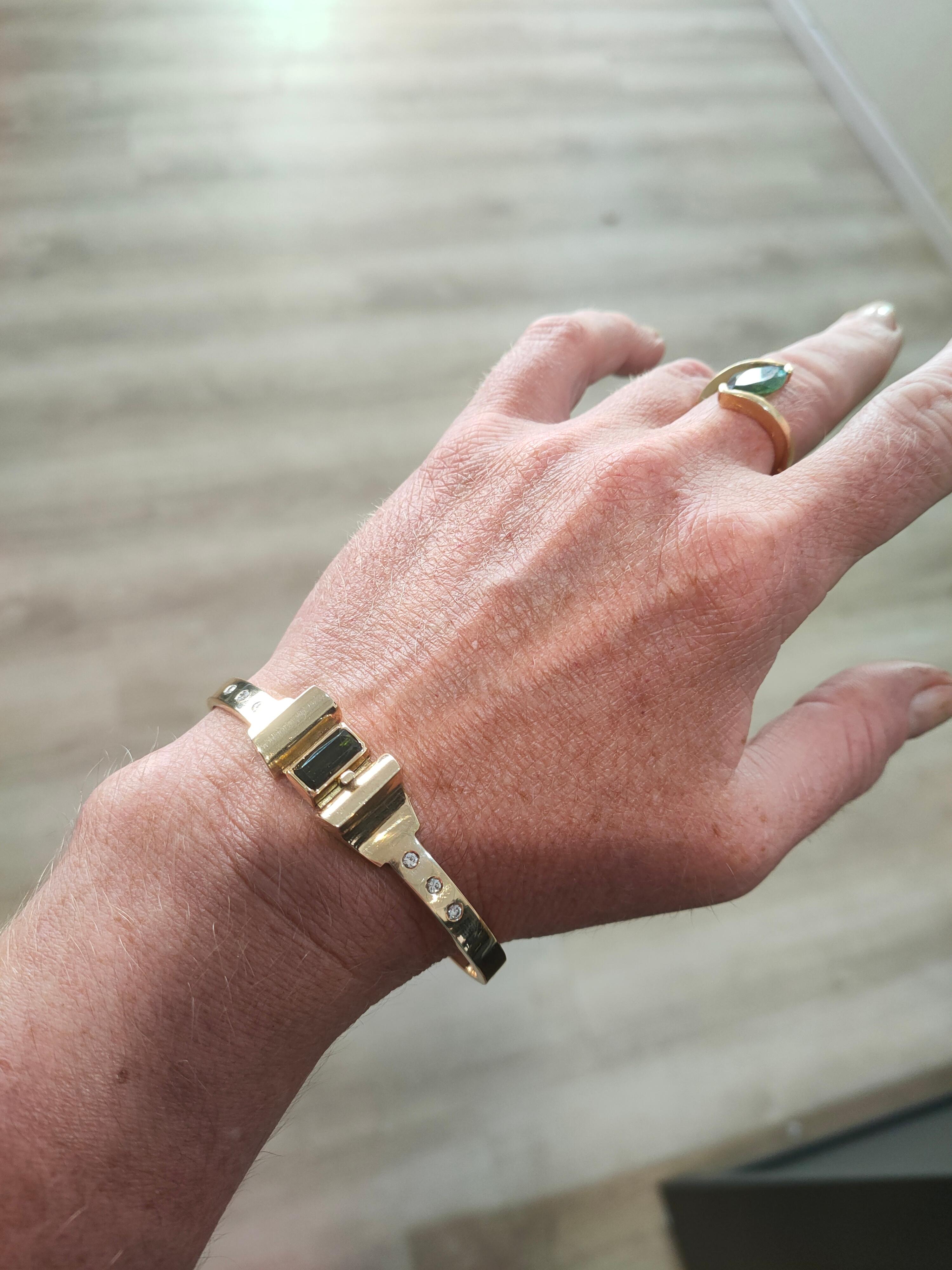 [specs below..]

With this 14 karat yellow gold bracelet, you are seriously wearing something. The bracelet weighs a total of 47 grams, making it pleasant to wear but palpably exclusive. In the middle of the Amsterdam School-based bracelet is the