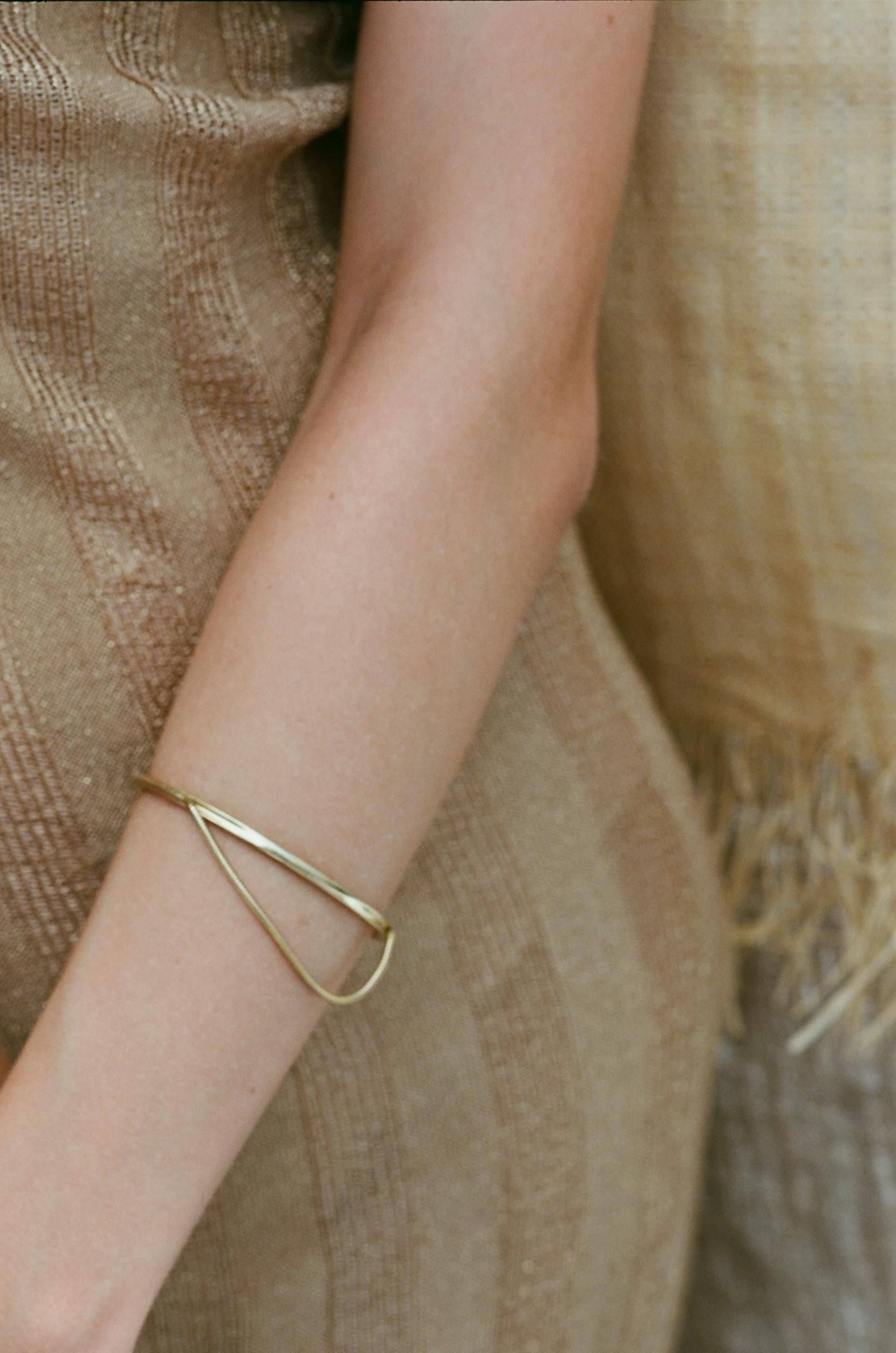 Arm Cuff 

A simple arm cuff,  highlighted by the movement of the snake chain. Hand-crafted by local skilled craftsmen. Made in Athens, Greece. 

This piece belongs to the Glow collection of Maggoosh. A collection is defined by the liquidity,
