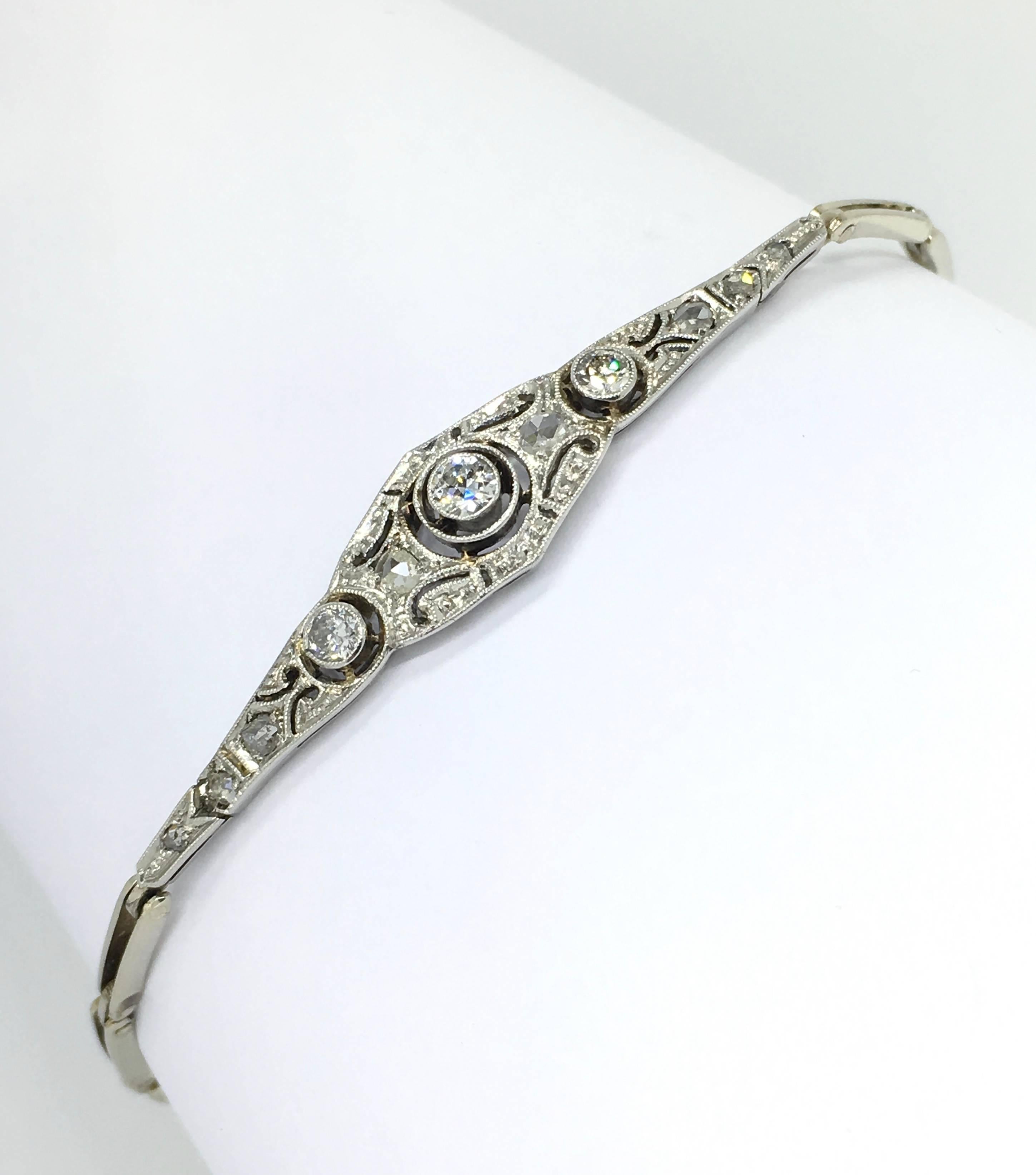 White Gold Art Deco bracelet, set with sparkling Old European and Rose Cut Diamonds. The reminded and typical Art Deco design with Millegrain decorated aplique is set with 11 diamonds.
The fine links with V spring closure and safety chain make this