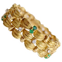 Bracelet circa 1960 Articulated in 18 Karat Yellow Gold Diamonds and Emeralds