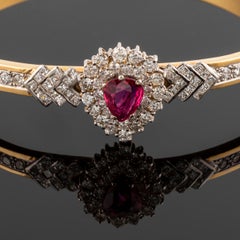 Cocktail clamper bracelet in gold, with teardrop-shaped ruby and diamonds