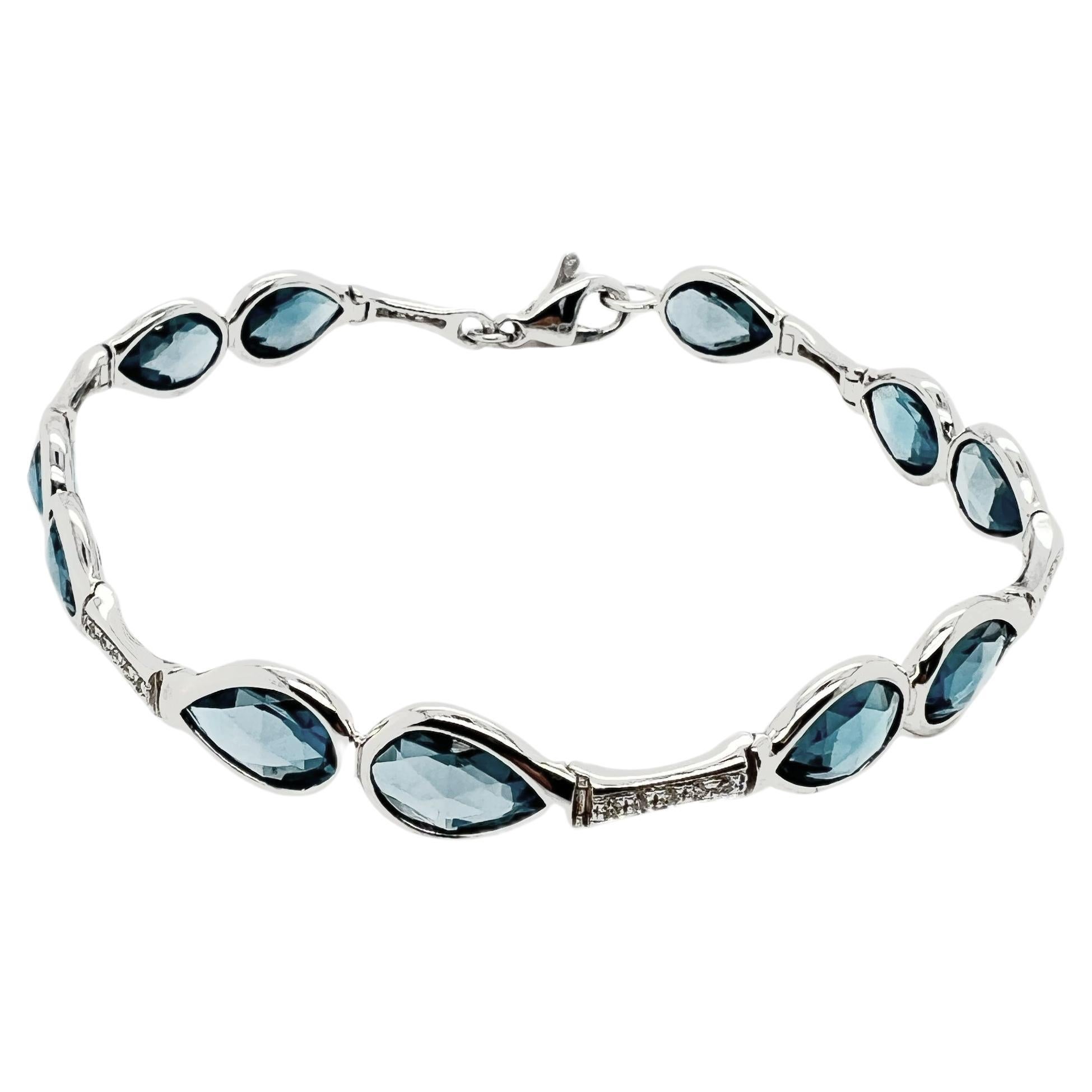 Bracelet in 18k gold with Diamonds and Blue Topaz drops