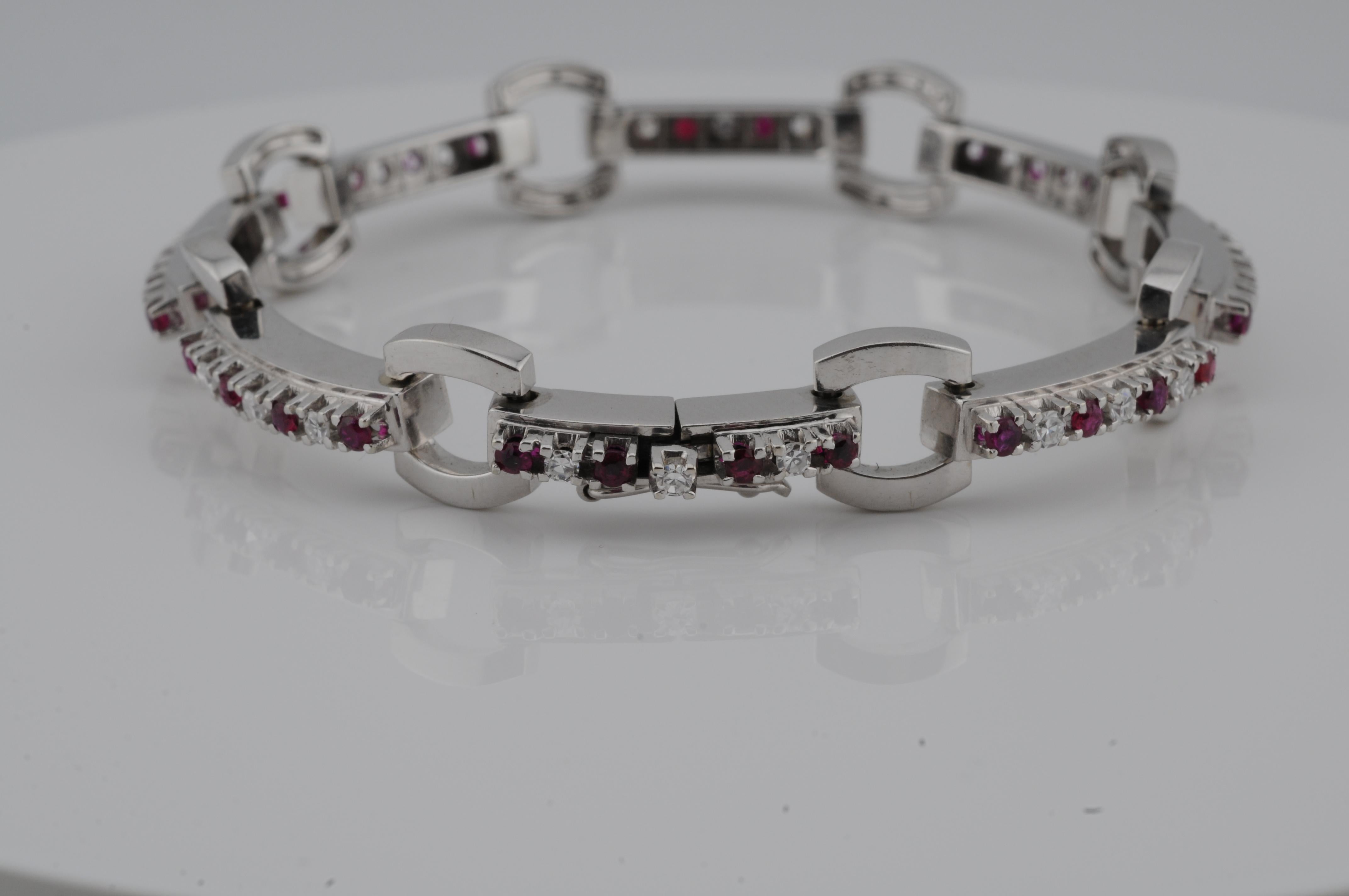 Bracelet in 18K white gold, set with 24 natural diamonds, each approx. 0.02 ct, and 32 Burmese rubies, each approx. 0.03 ct.

The stones are evenly arranged in fine bezel and prong settings, creating a balanced play of color between the deep red of